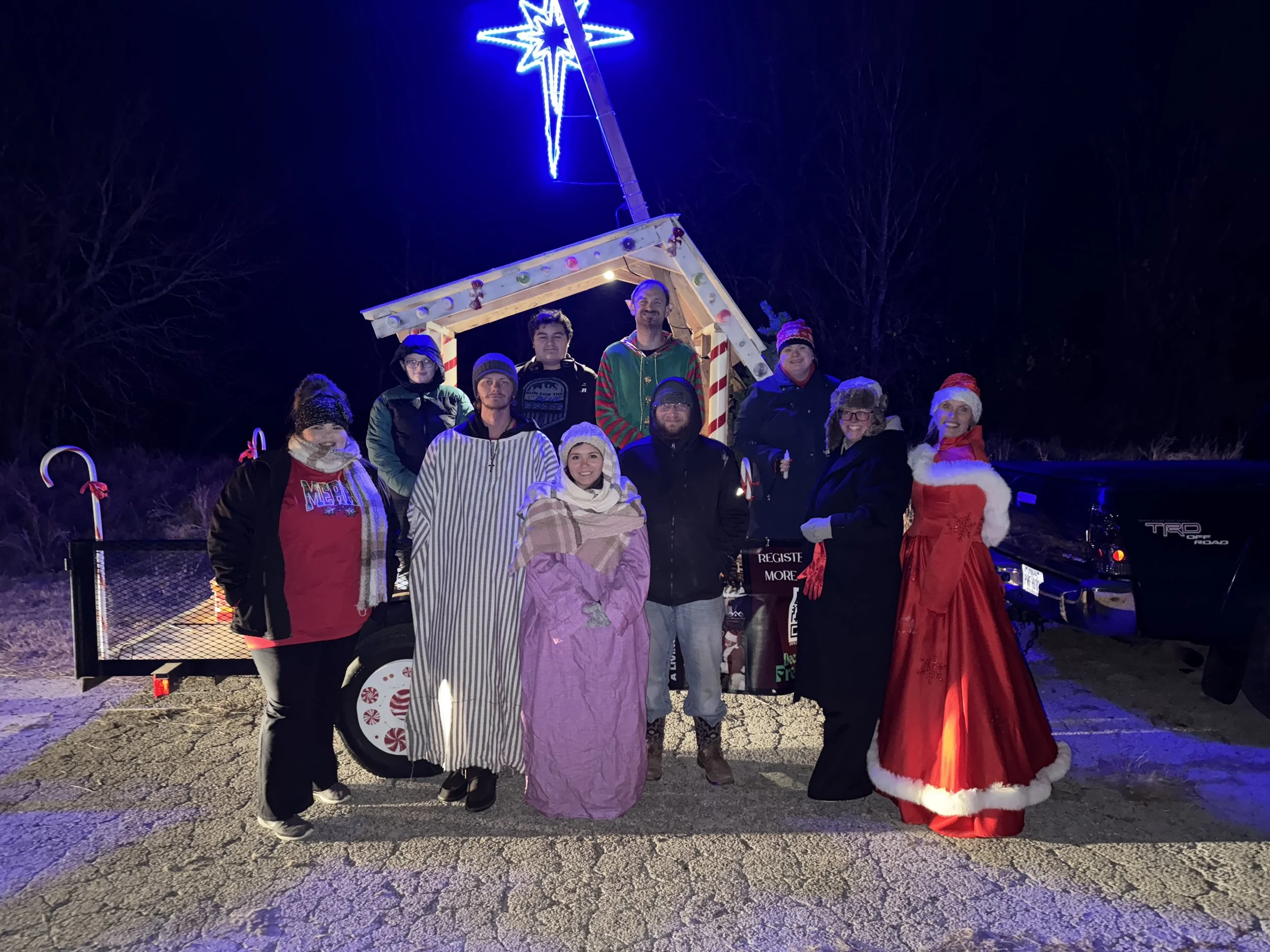 Mistletoe Farm volunteers spreading joy from a Christmas parade float, celebrating community and connection during the holidays