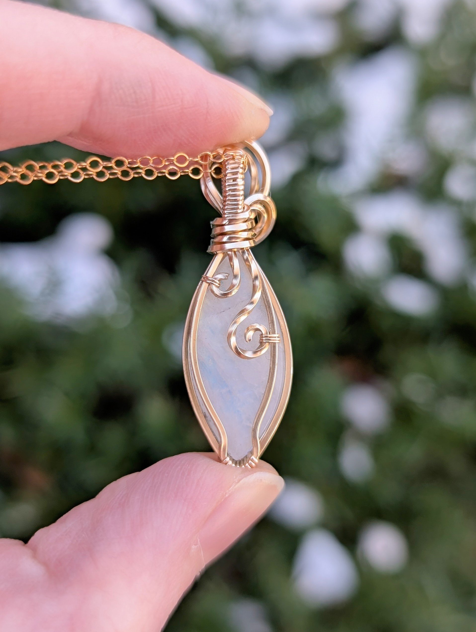 The back of a pendant made with a marqui-shaped moonstone and 14k gold filled wire in soft light. No flash showing.