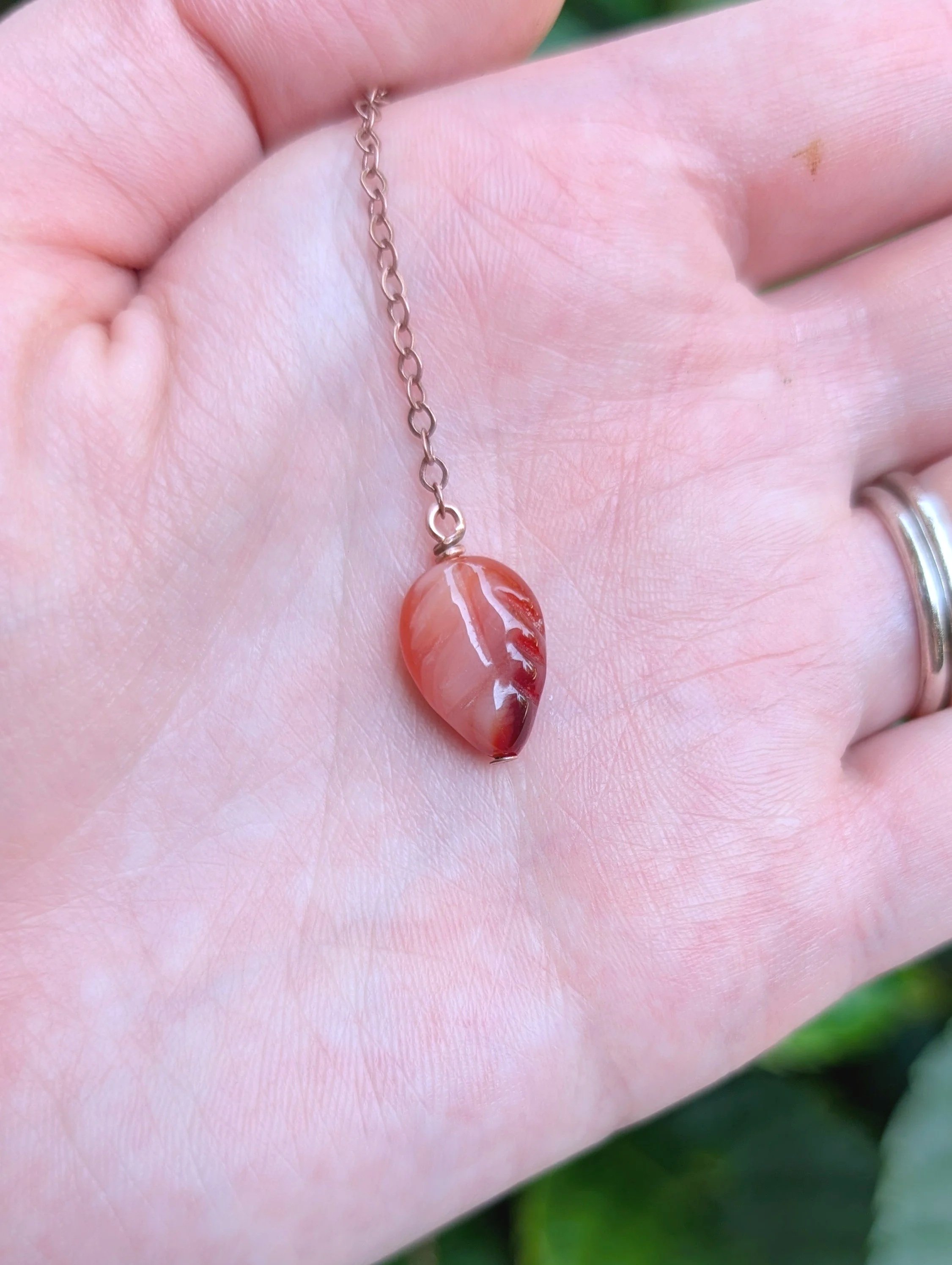 carnelian end of Cascading Leaves Lariat Necklace with Carnelian in Copper