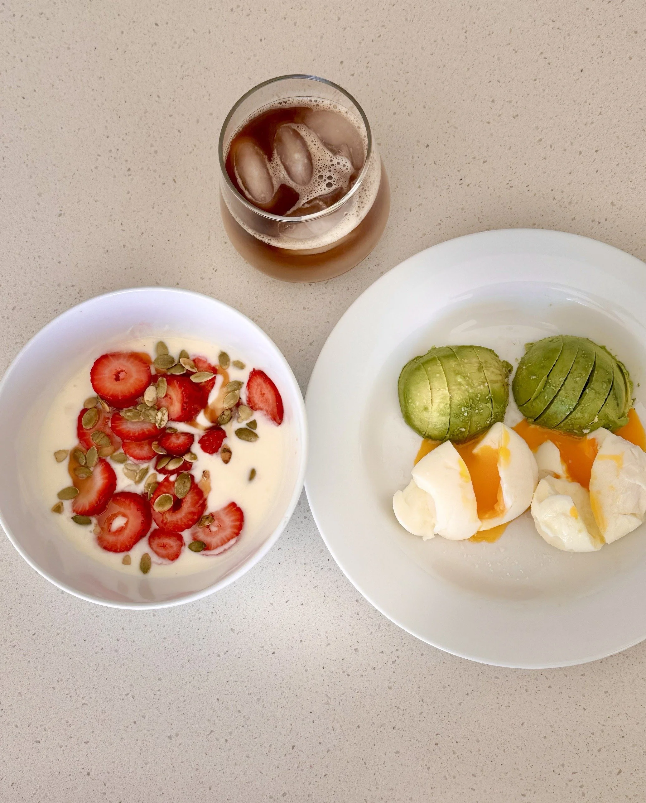 Yogurt breakfast bowl topped with fruit and seeds