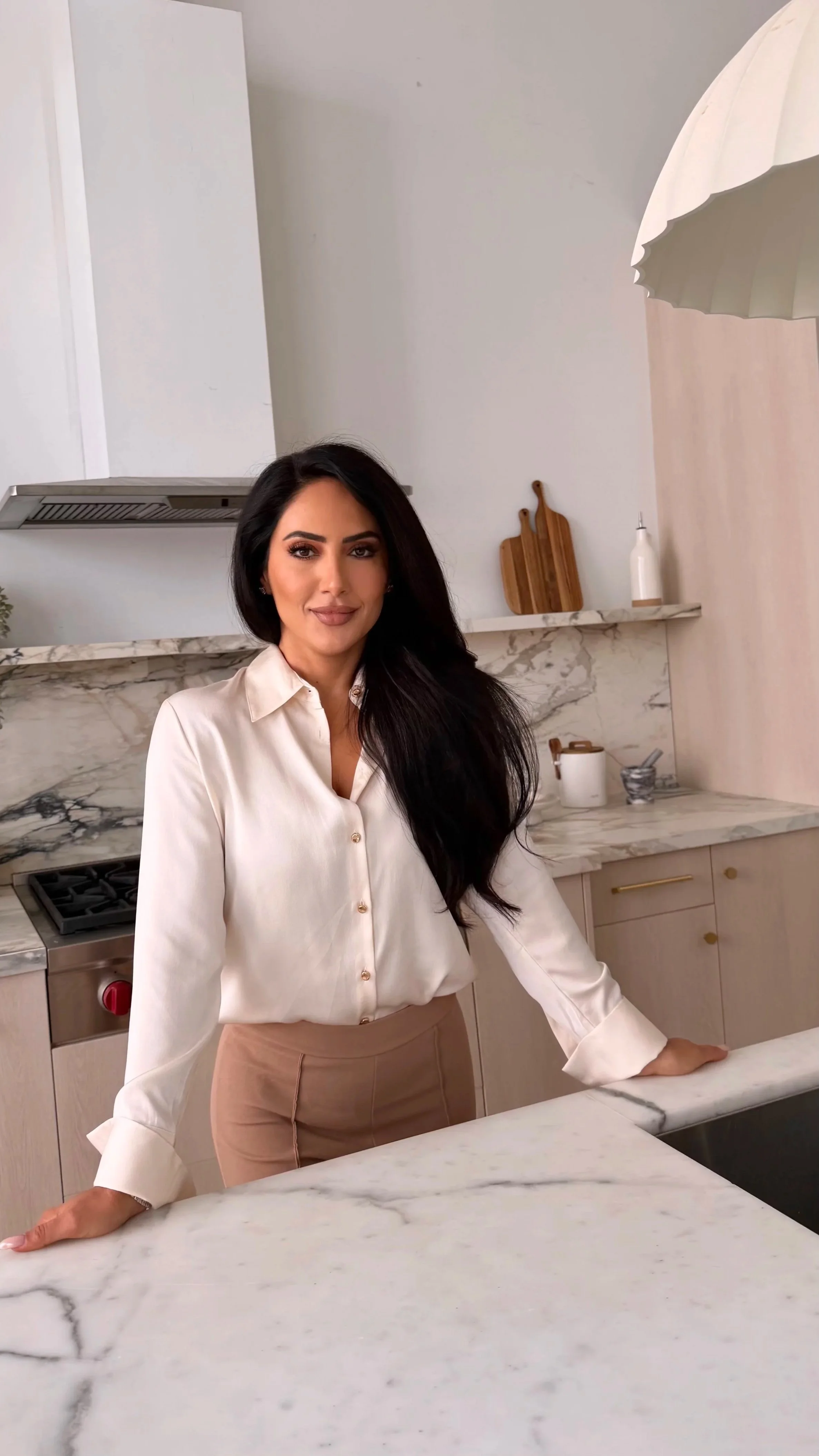 Sydney Sajadi in her kitchen with marble countertops, representing the Vitality Journey program
