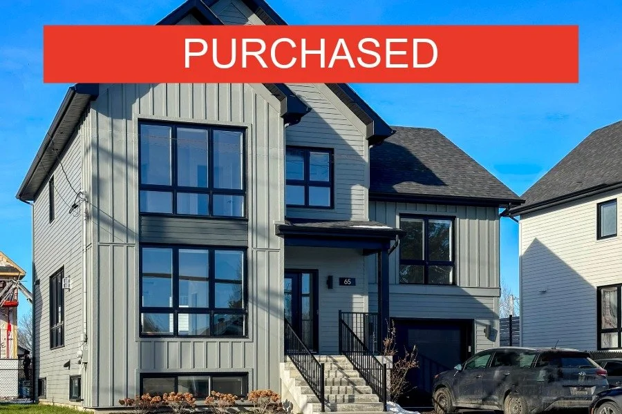 Newly purchased modern gray multi-story house with black-framed windows, a staircase leading to the front door, and a black SUV parked in the driveway