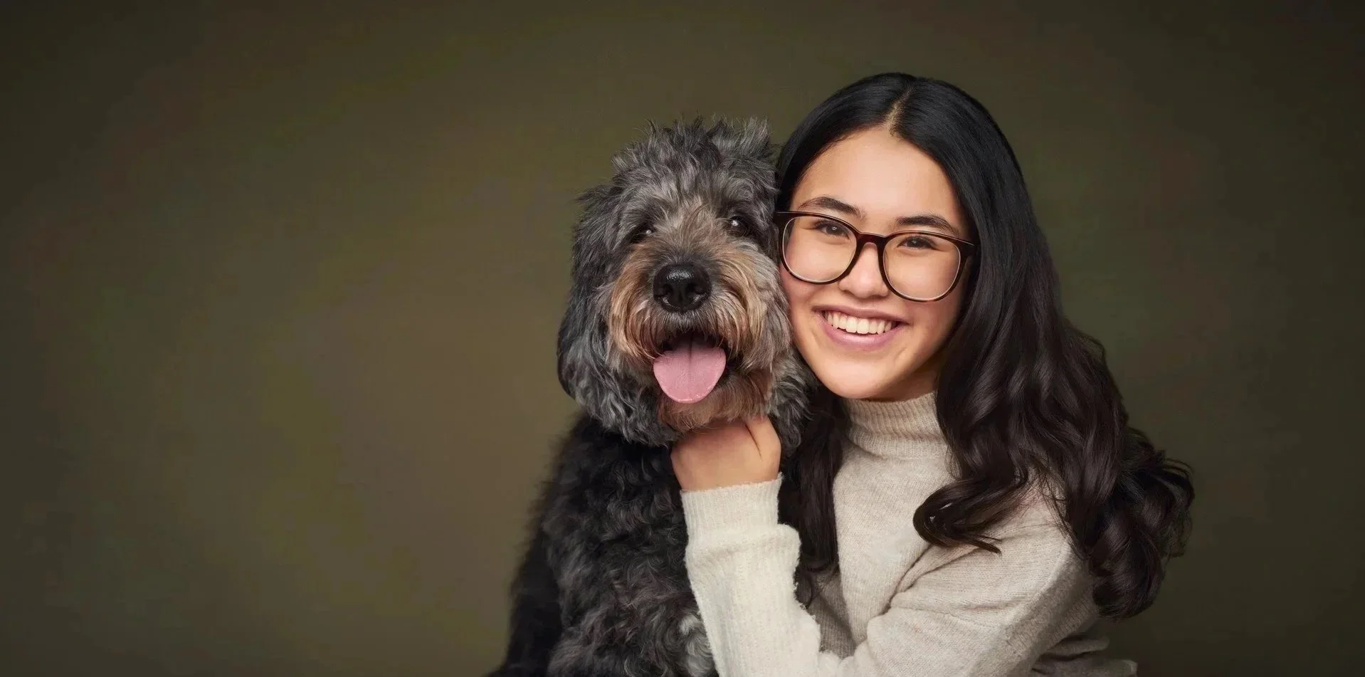 Girl holding her dog during a pet and family portrait session