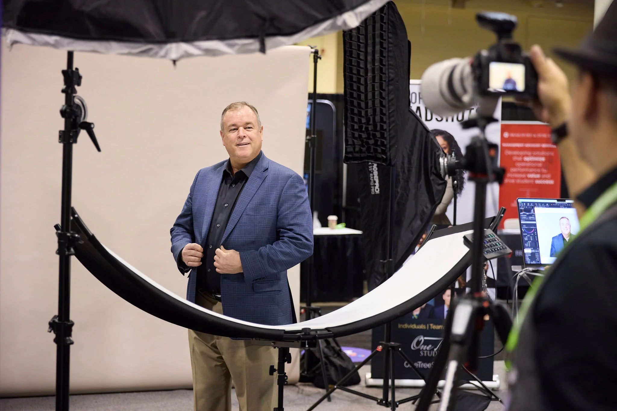 One Tree Studio photographer and conference attendee in Headshot Booth.
