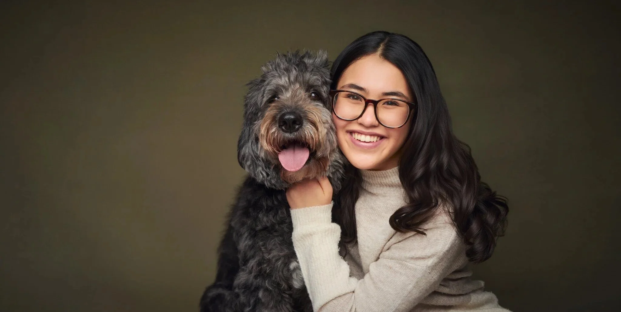 Girl holding her dog during a pet and family portrait session