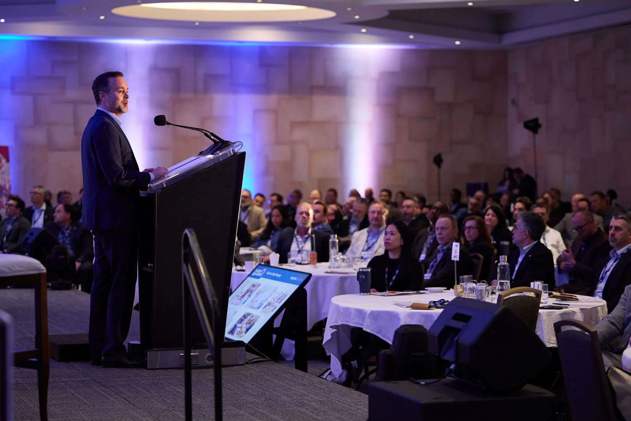 Speaker addressing attendees during Sofina Foods' corporate conference at White Oaks Resort Niagara.