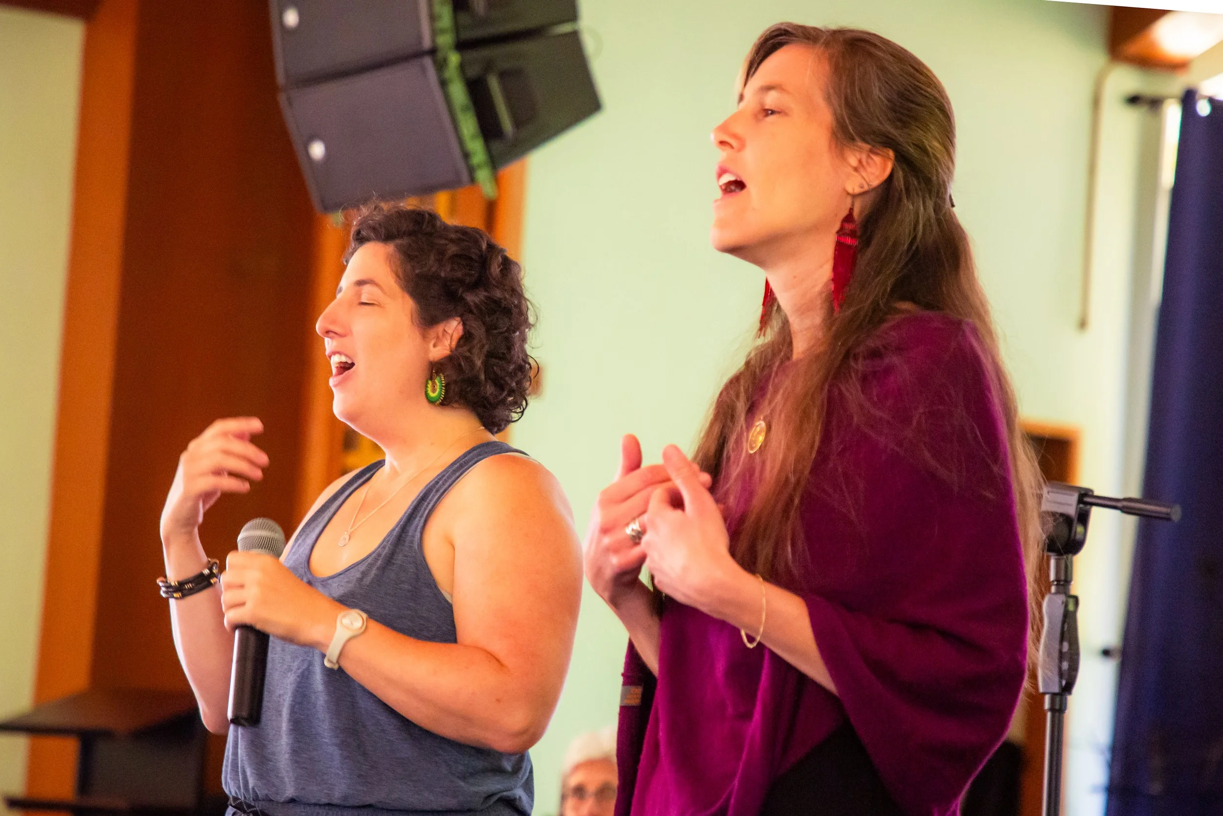 Amanda West singing during a community music gathering.