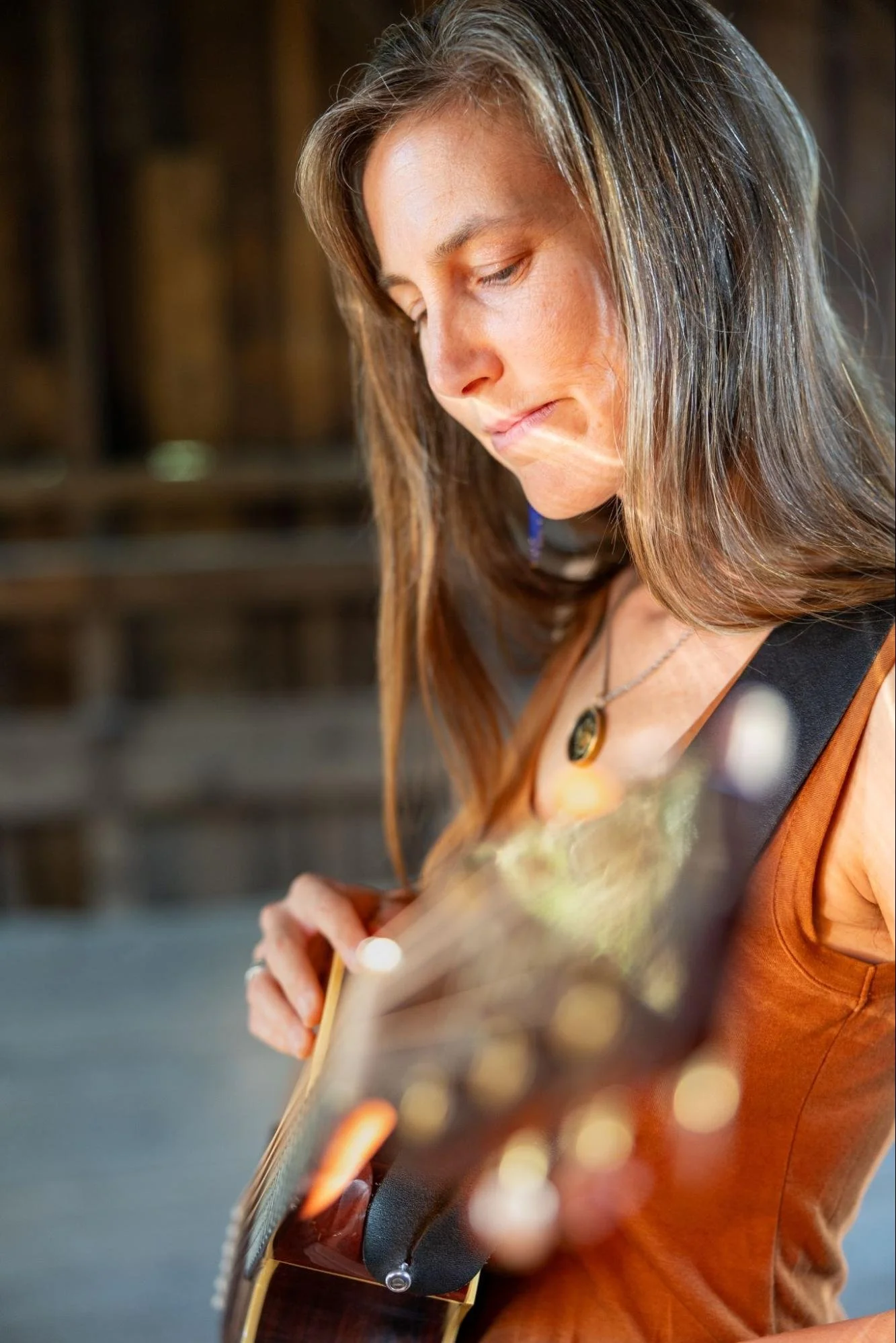 Amanda West playing music in warm natural light.