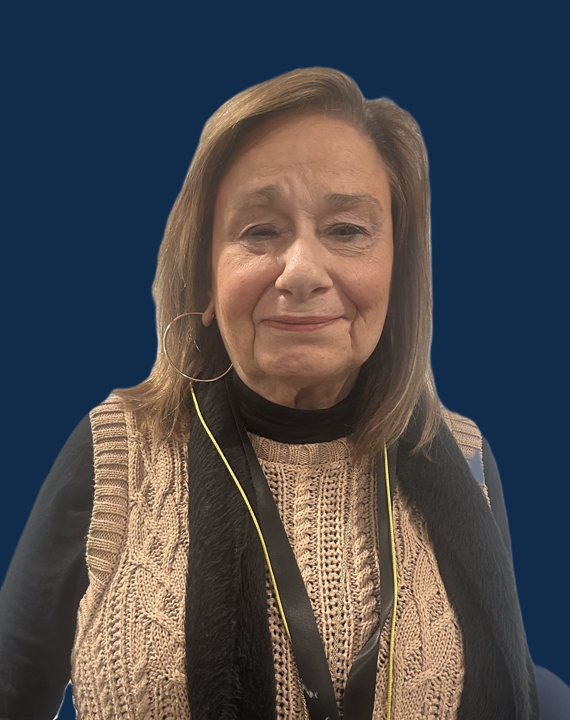 A large, leafy tree in a park with children playing nearby, soccer goals on the grass, and a tall blue building in the background.