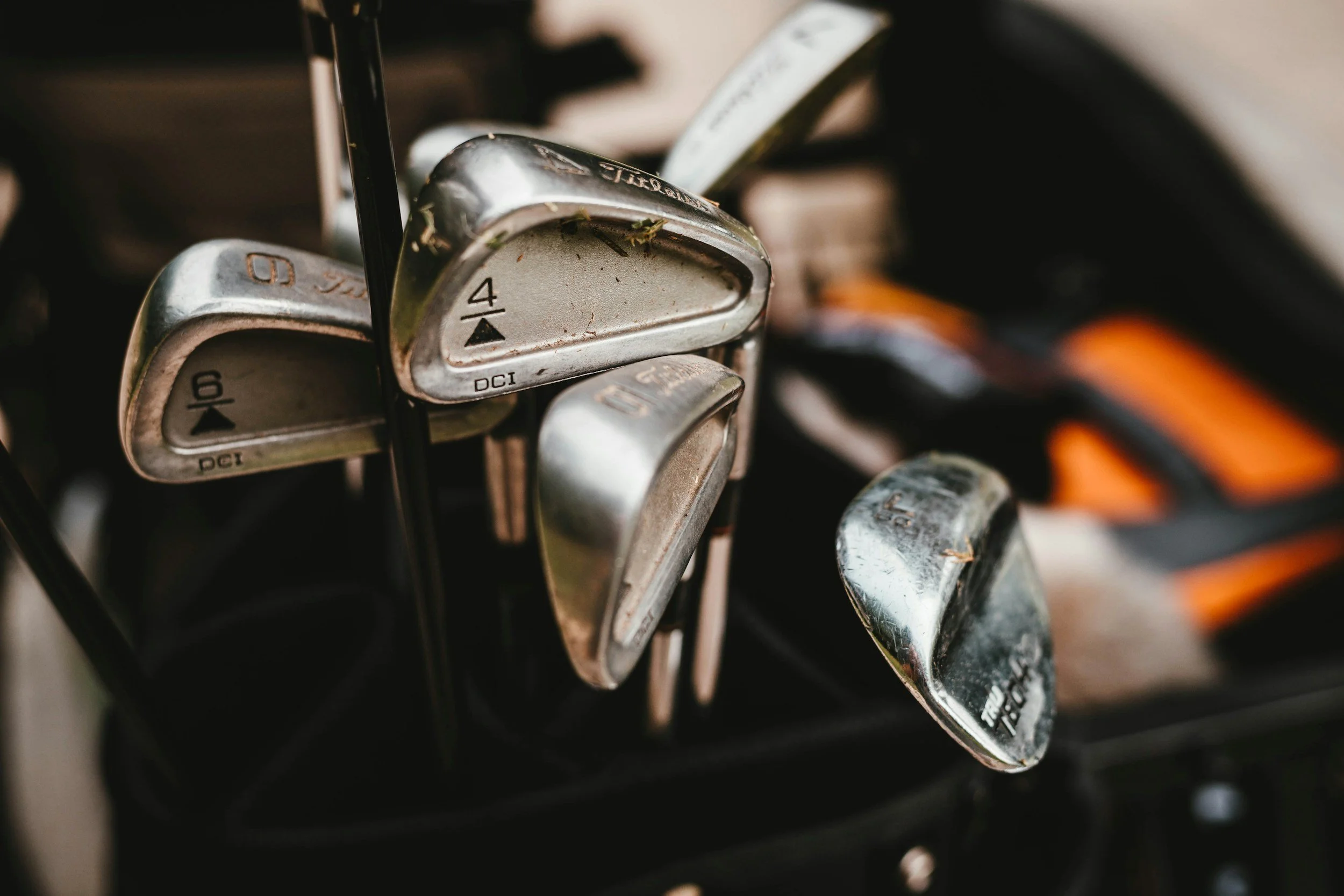 Close-up of a set of golf clubs in a golf bag.