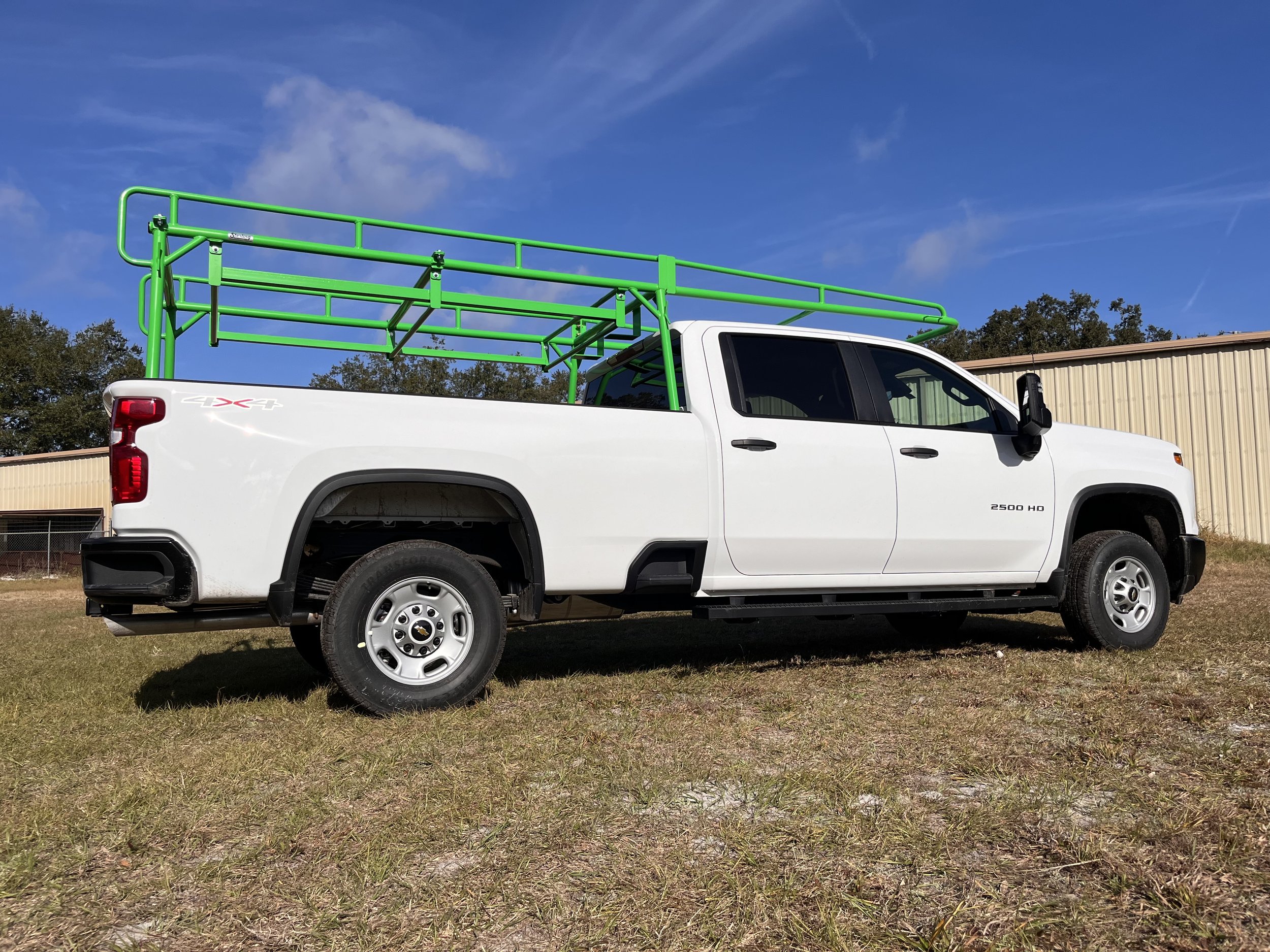 Sterling Truck Rack painted green in a field