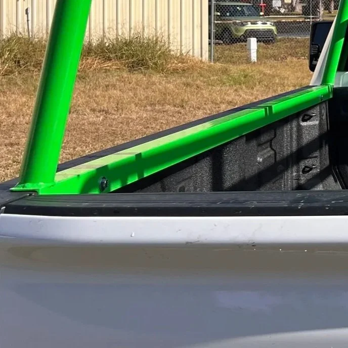 zoomed in photo of a mount pad for a truck rack that has been painted green