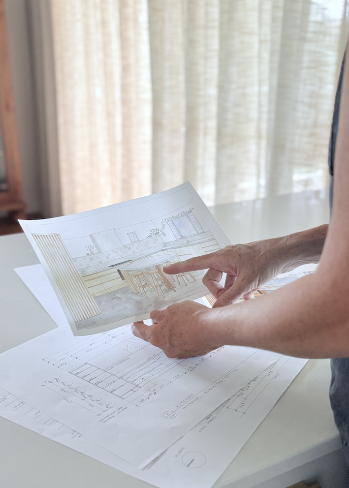 Reviewing a kitchen interior render alongside technical drawings — a working moment in the Oliv Interiors studio, Newcastle.
