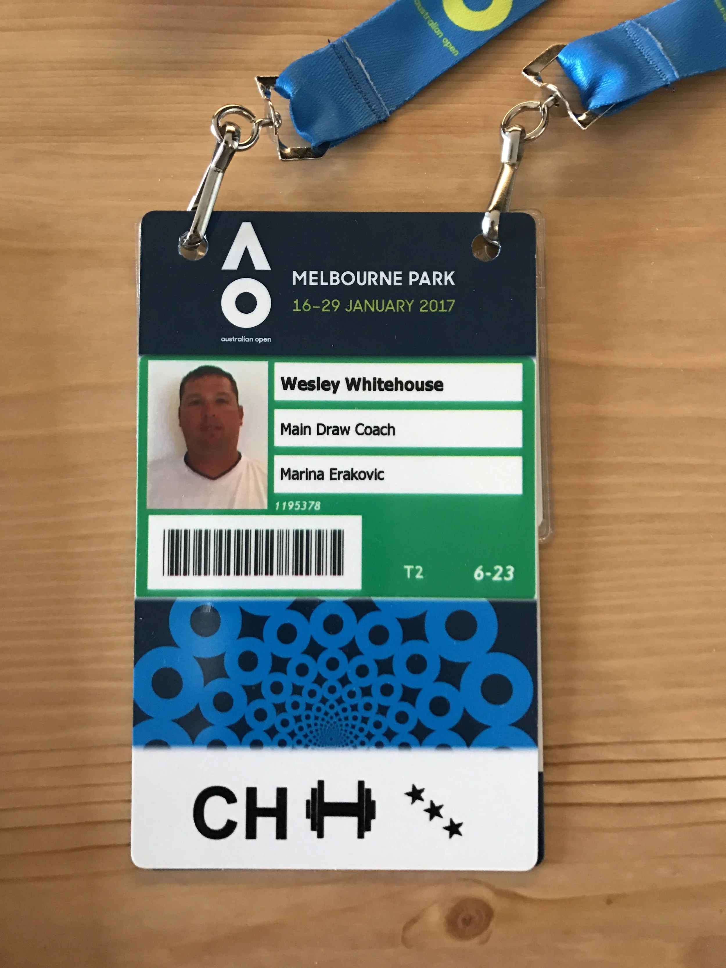 An event badge for Wesley Whitehouse at the Australian Open 2017 at Melbourne Park. It includes a name, a photo, and details about the role of a main draw coach. Attached to a blue lanyard.