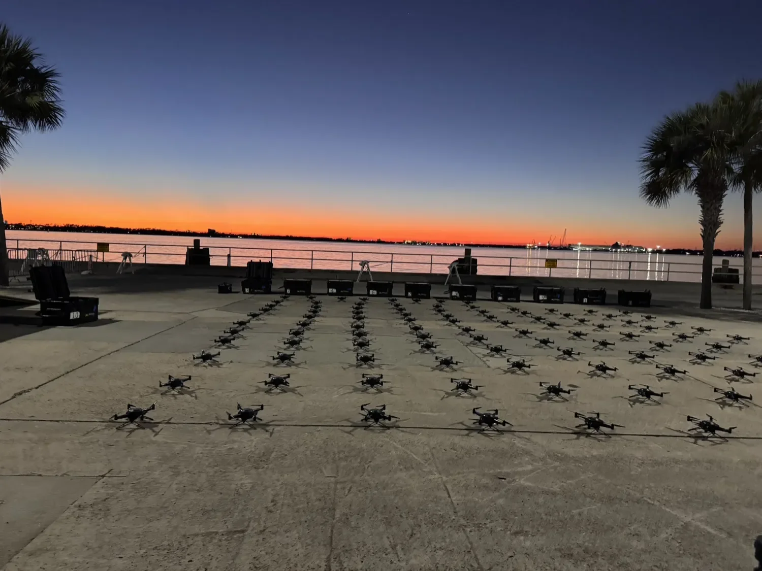 Orion Skys crew setting up a drone light show on a waterfront at sunset