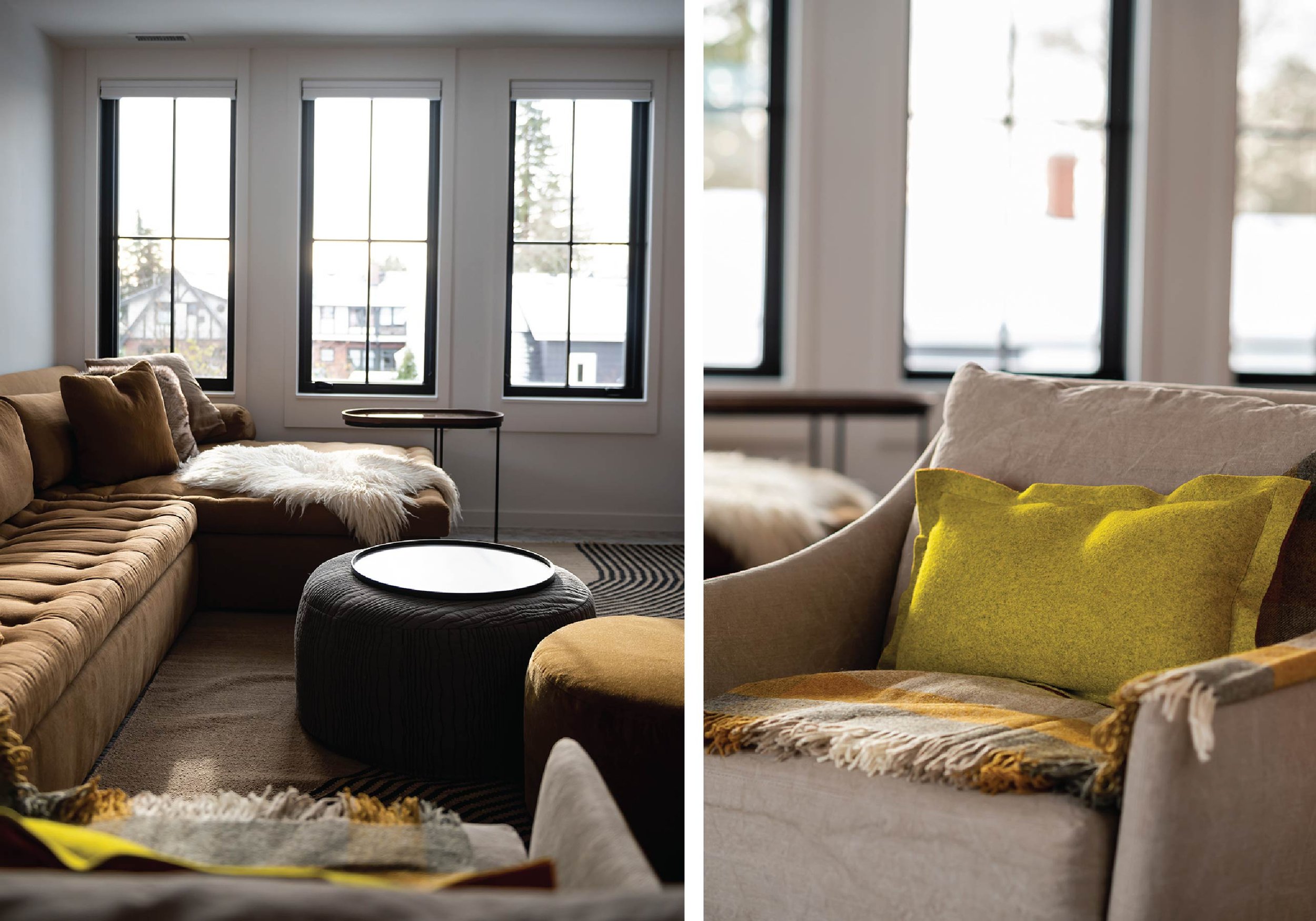 Modern living room interior with large windows, brown sectional sofa, plush cushions, fuzzy throw, round ottoman with a tray, and yellow accent pillow on a beige armchair.