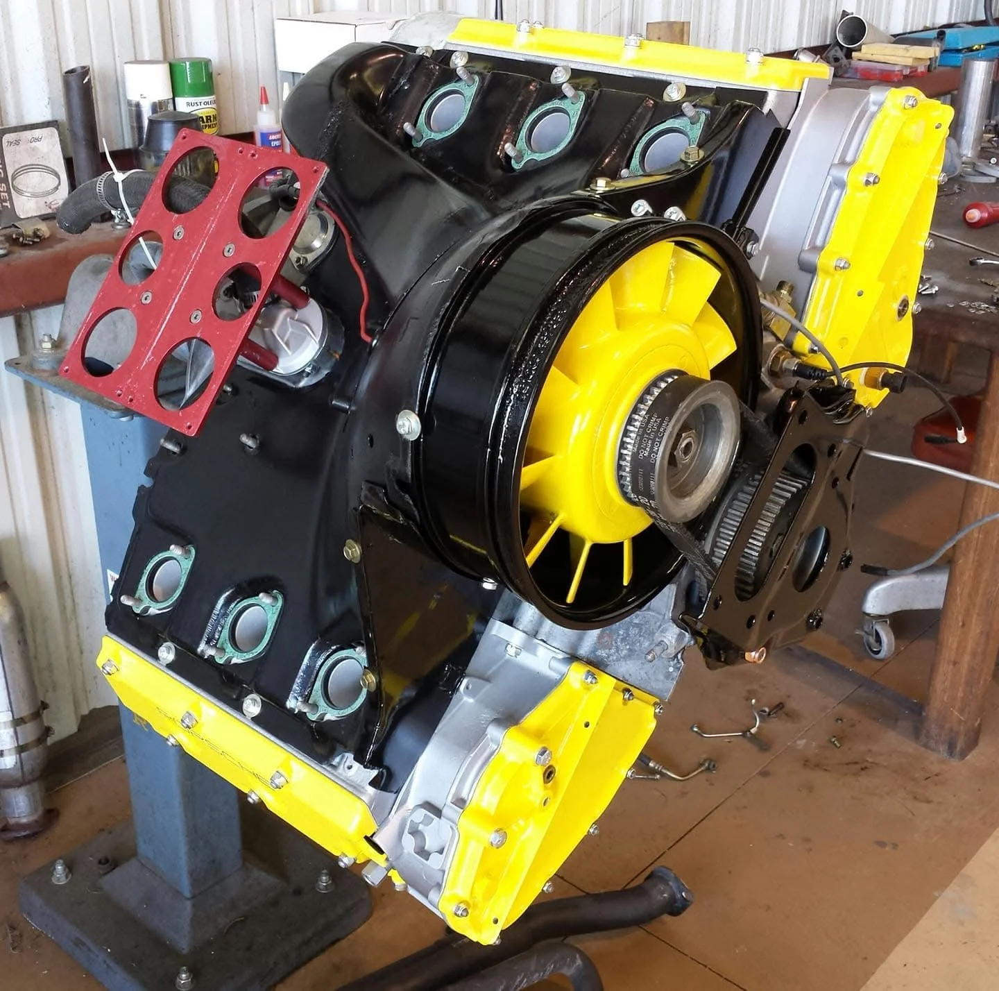 Large radial engine with yellow fan in a workshop setting