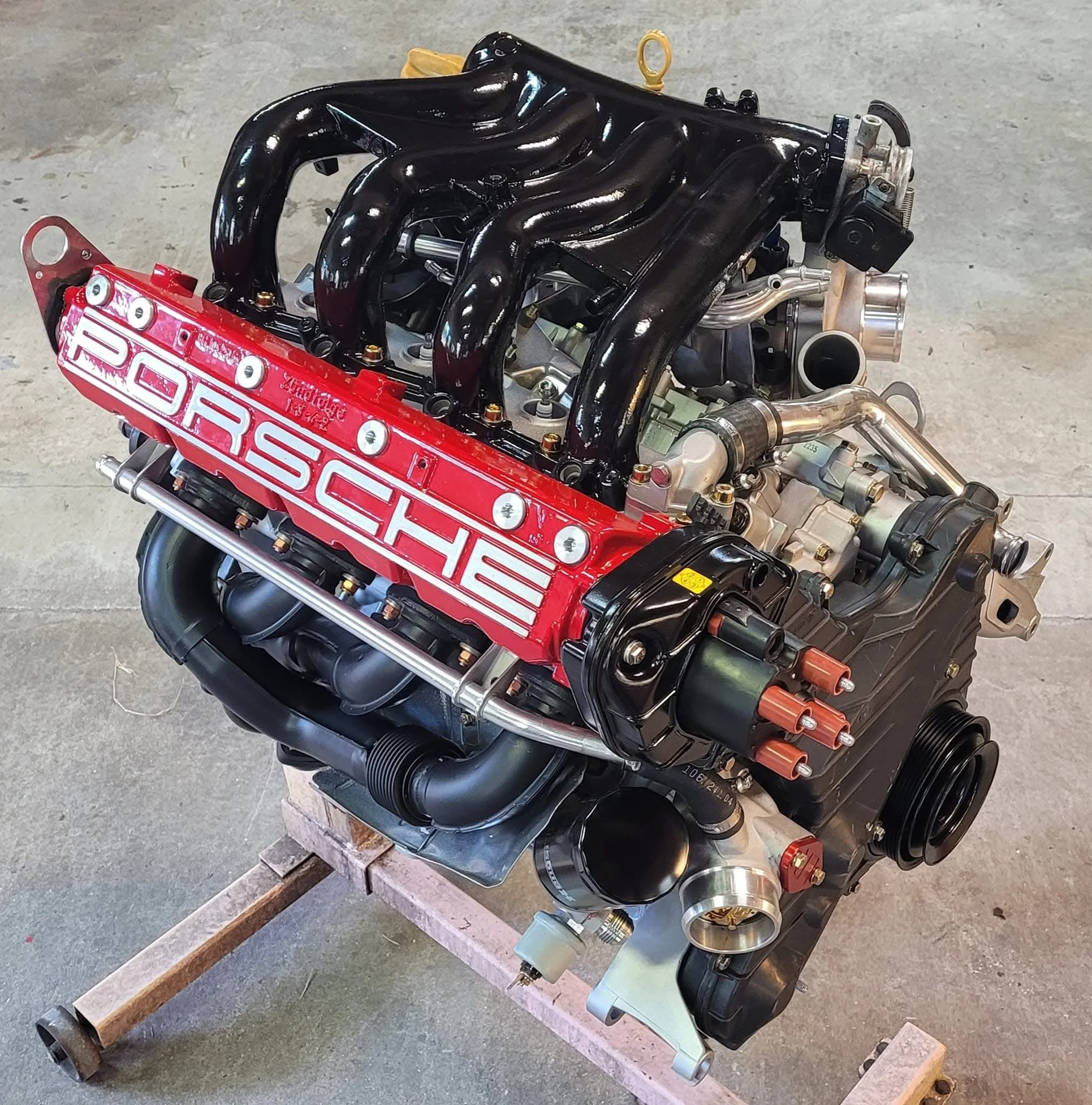 Porsche engine on a stand in a workshop