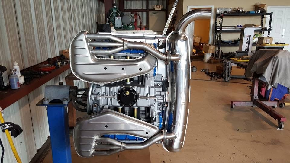 German flat-six air-cooled engine with exhaust system in a workshop