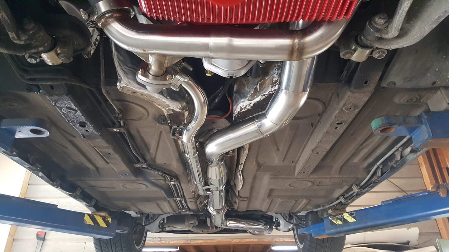 Car undercarriage with exhaust system on a lift