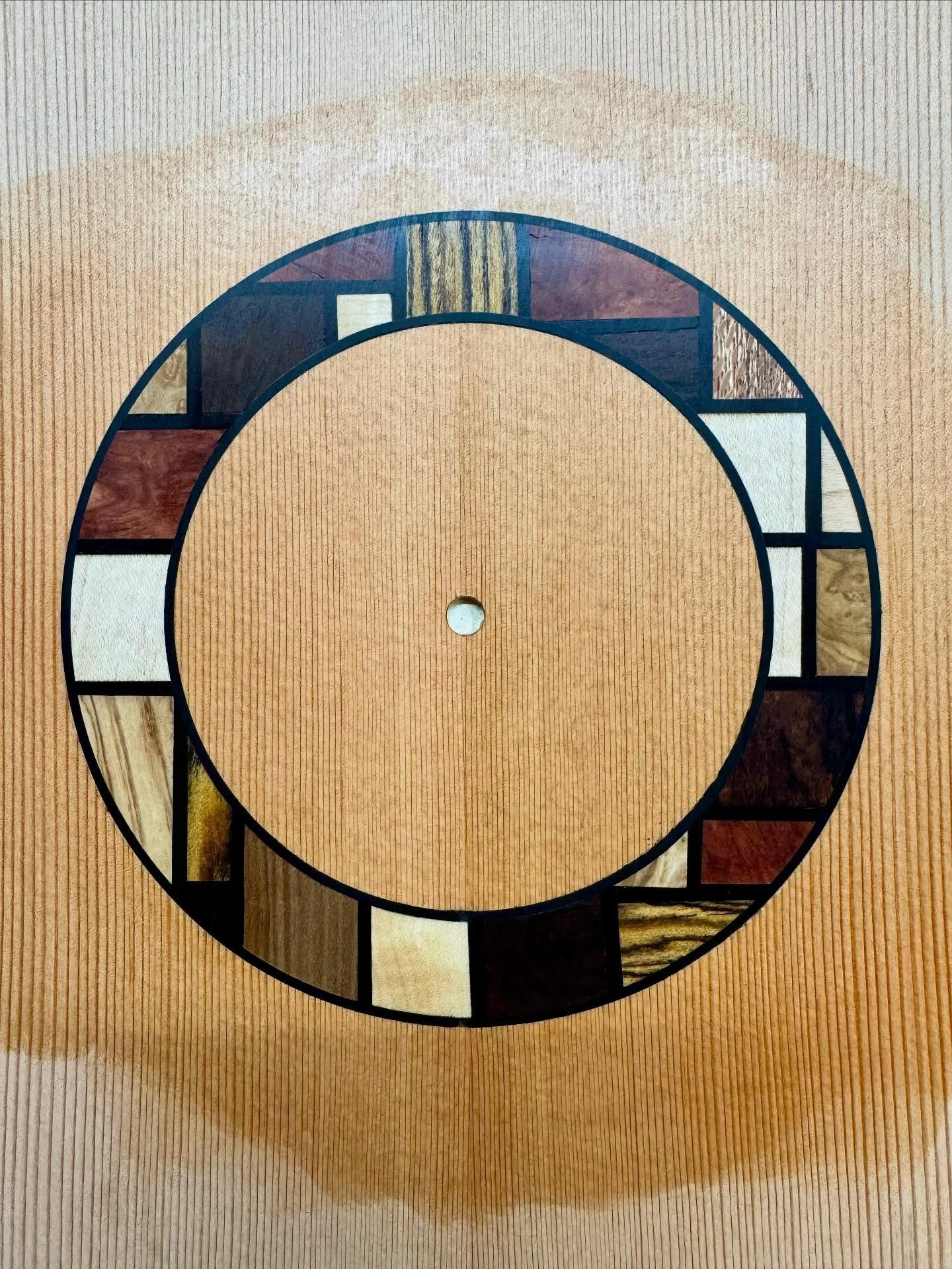 Kris is making a parlour sized acoustic guitar in my guitar making course. 

He has a background in design and has done some really nice work with his rosette. He based the design from a painting by abstract artist Piet Mondrian. 

The Timbers used i