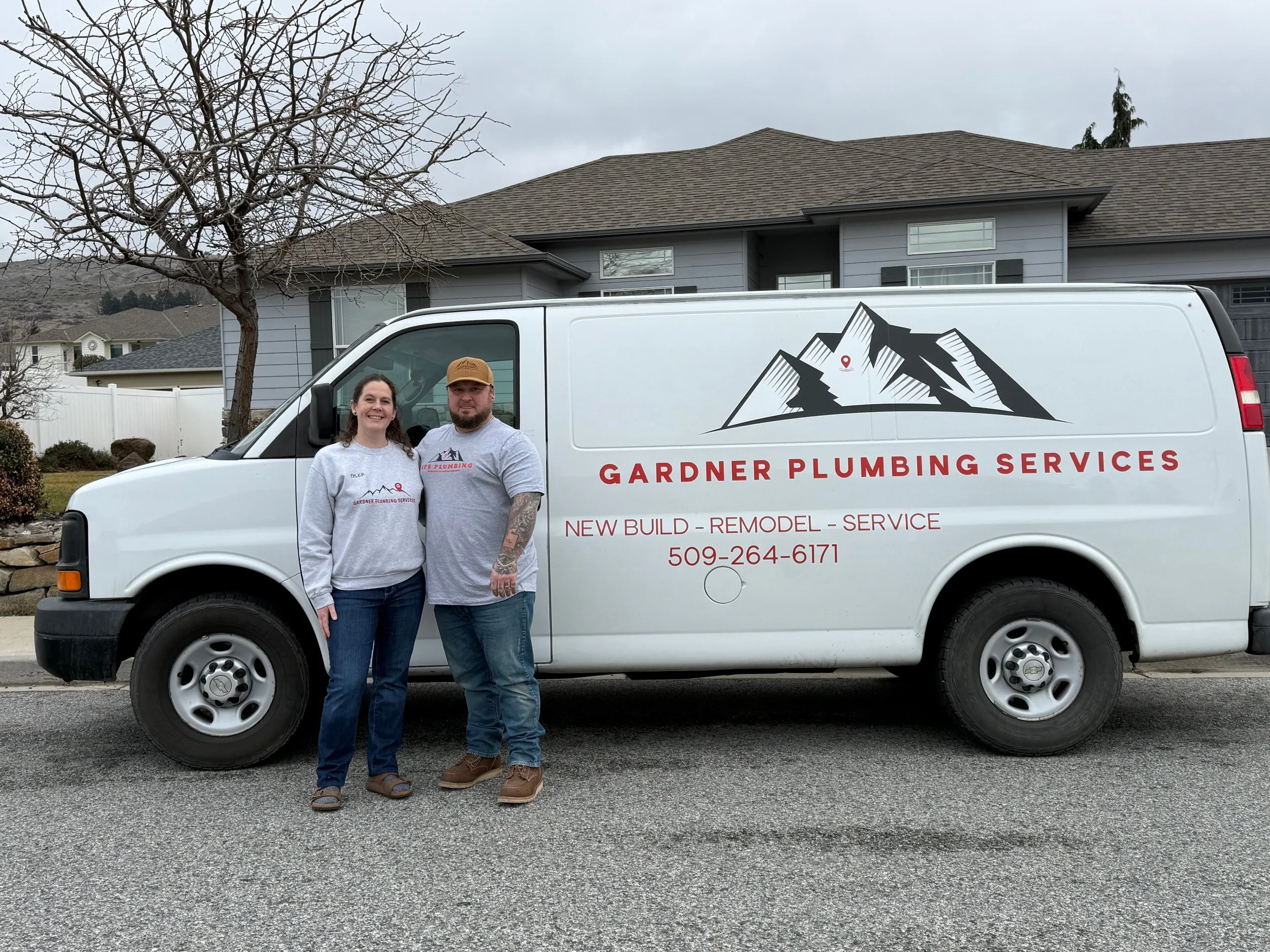 Gardner Plumbing Services owners standing beside their work van in Wenatchee, Washington