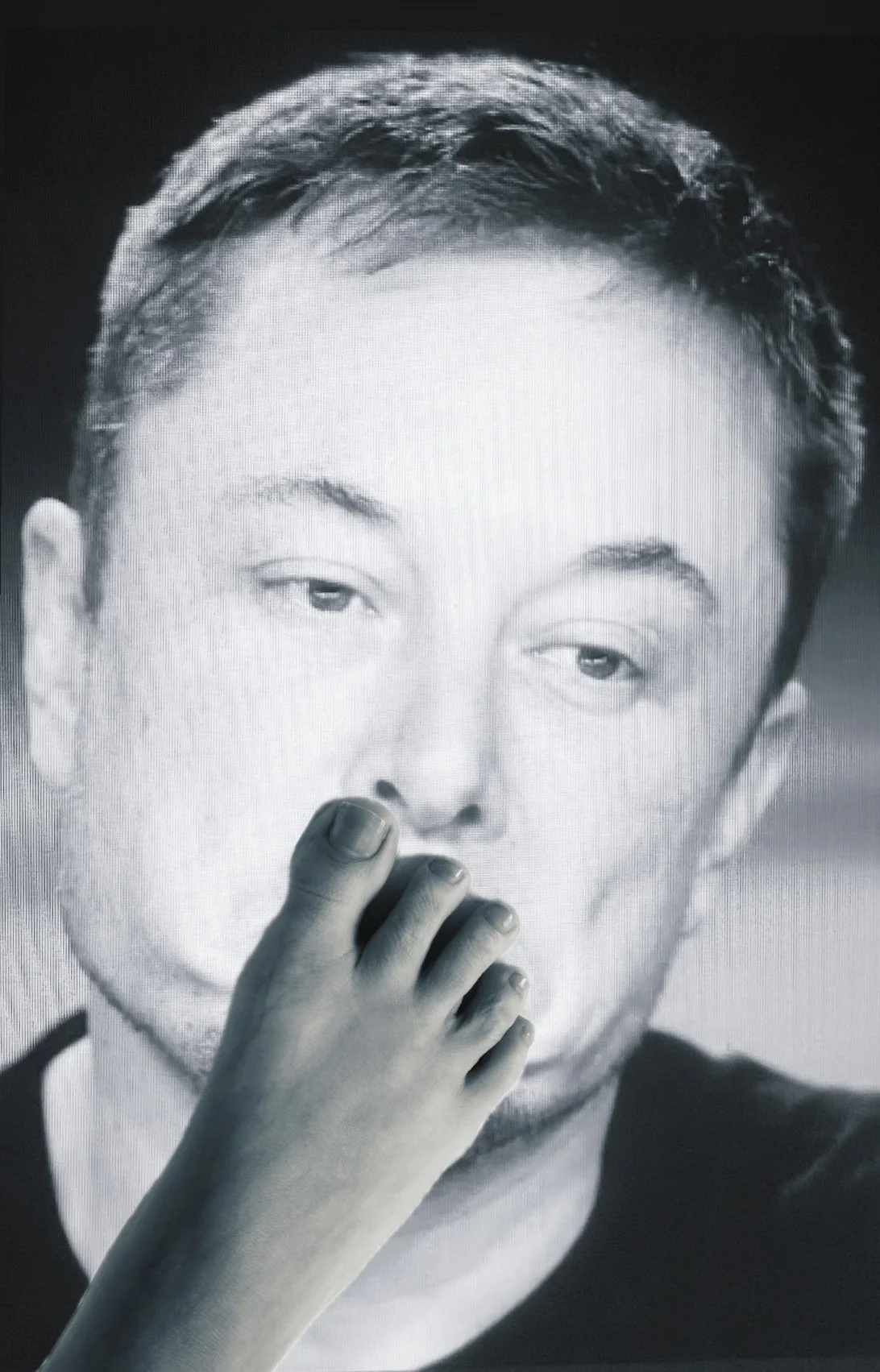 face of elon musk with foot over mouth