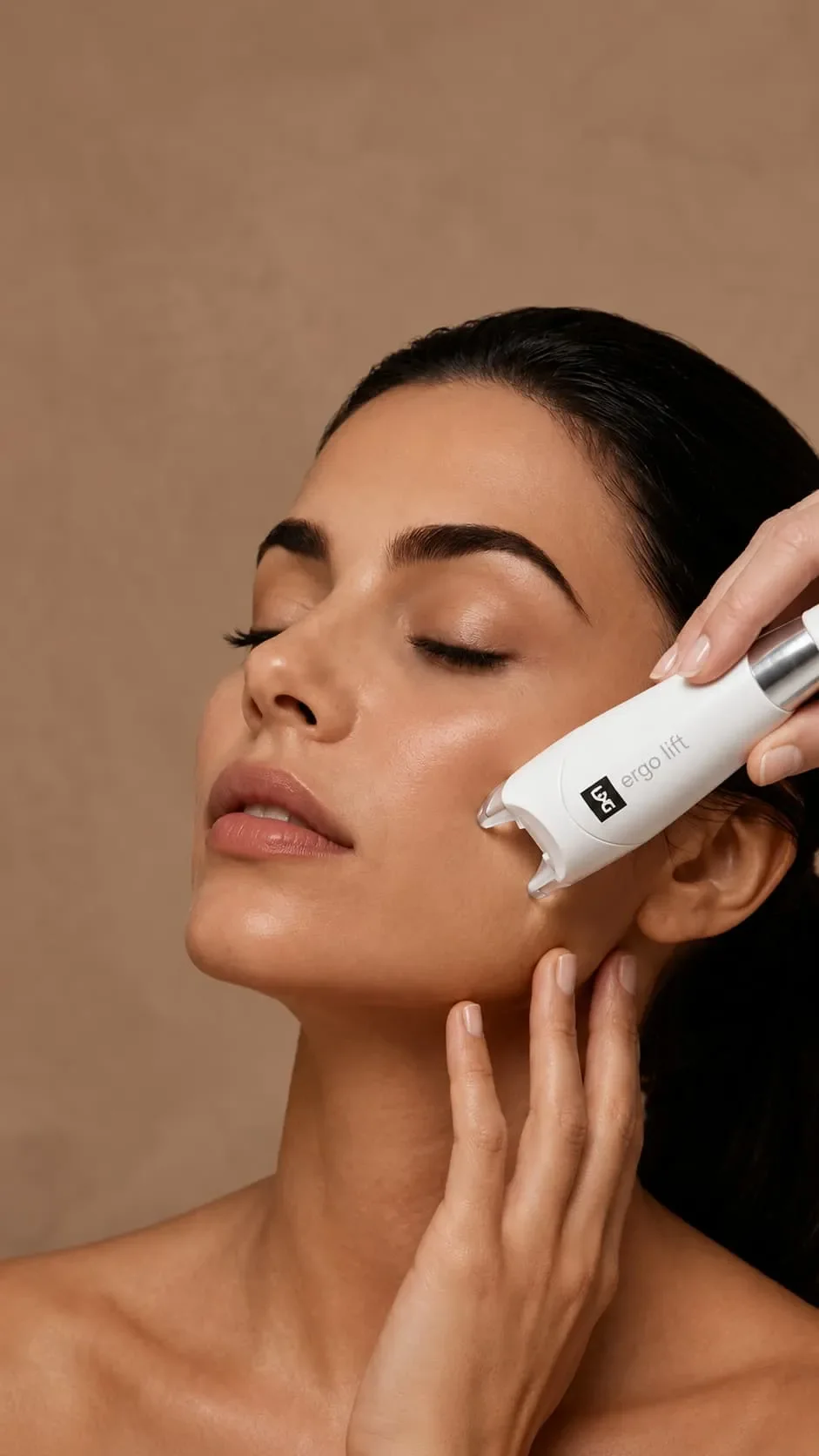 A woman receives a facial lymphatic drainage treatment with an LPG handheld device.