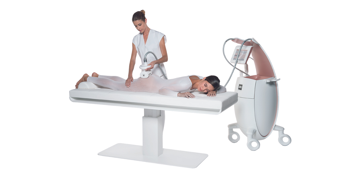 Medical professional performing a treatment on a woman lying on a bed in a medical imaging room with a large MRI machine.