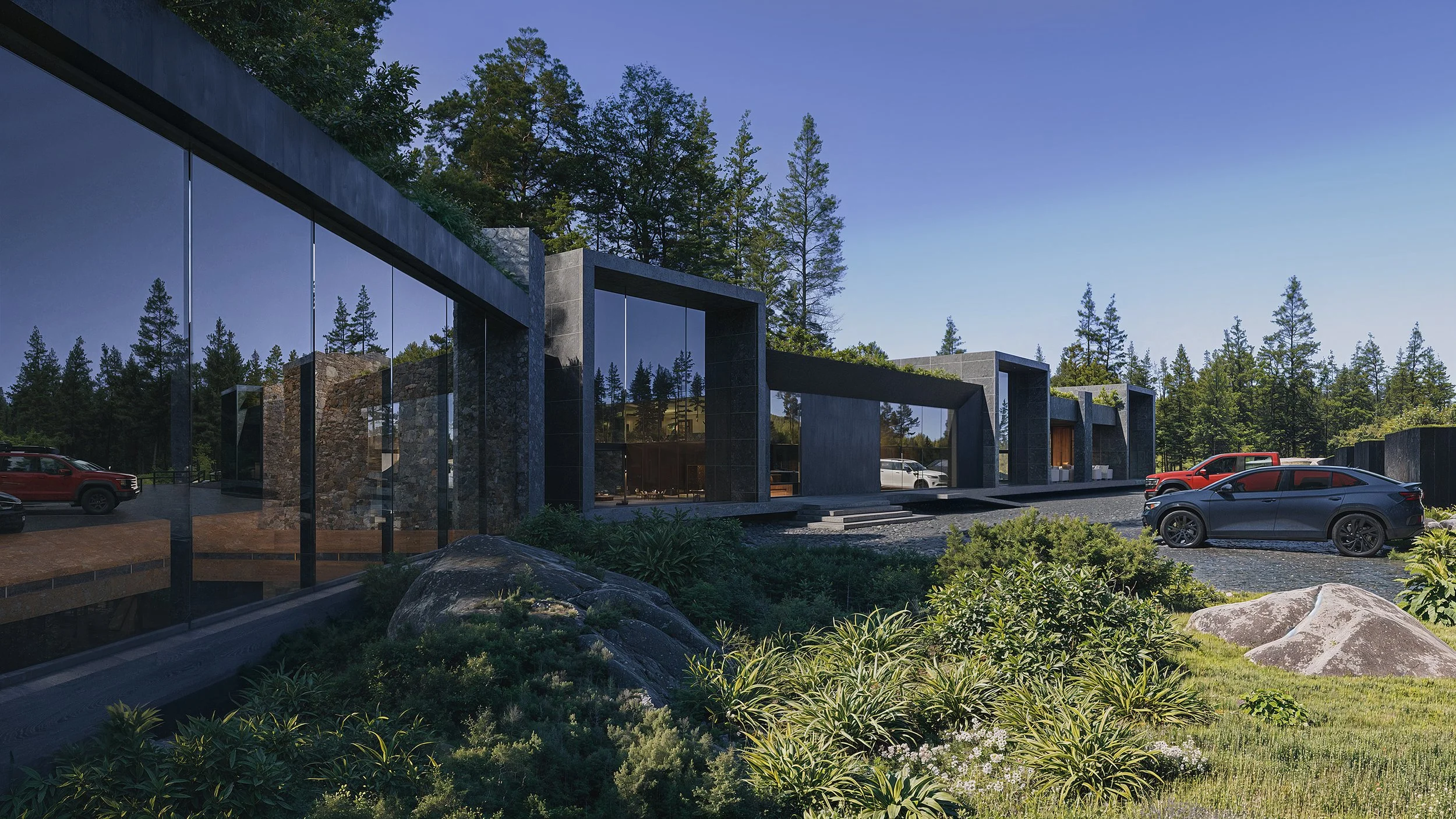 Modern building with large glass windows and dark stone accents, surrounded by greenery and trees, with parked cars in the foreground during daytime.