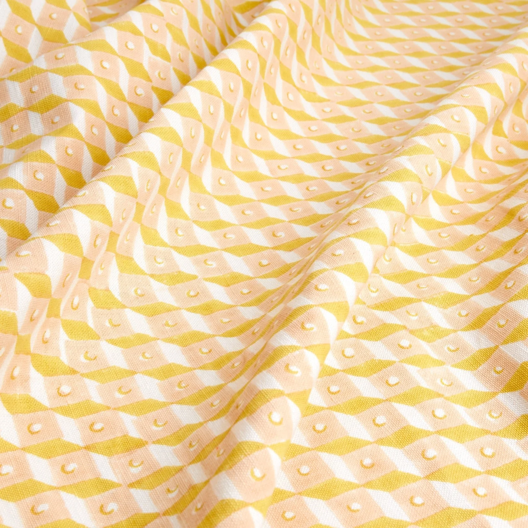 Yellow and white patterned fabric with geometric and smiley face motifs.