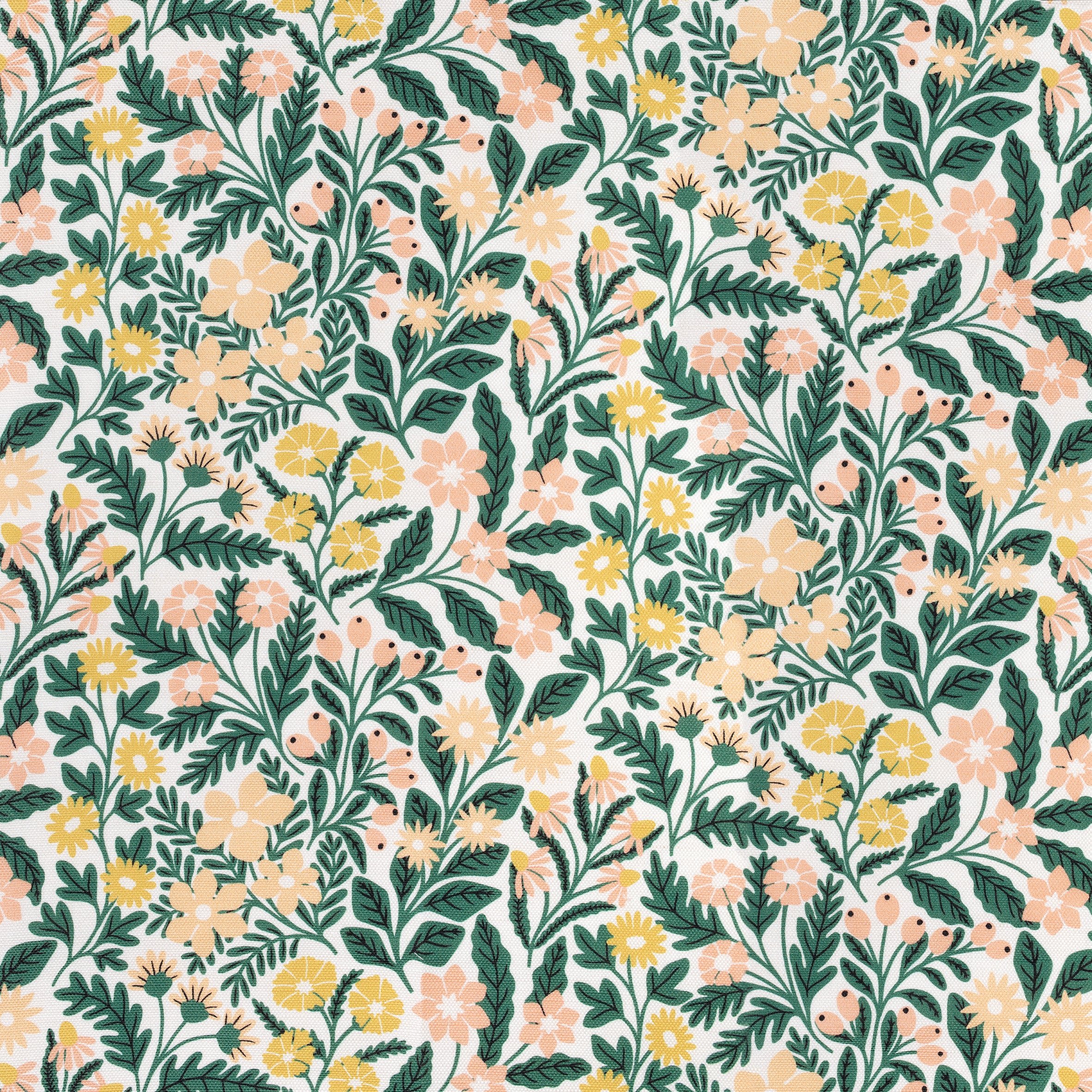 A colorful floral patterned fabric with various flowers in shades of pink, yellow, and cream, along with green leaves on a white background.