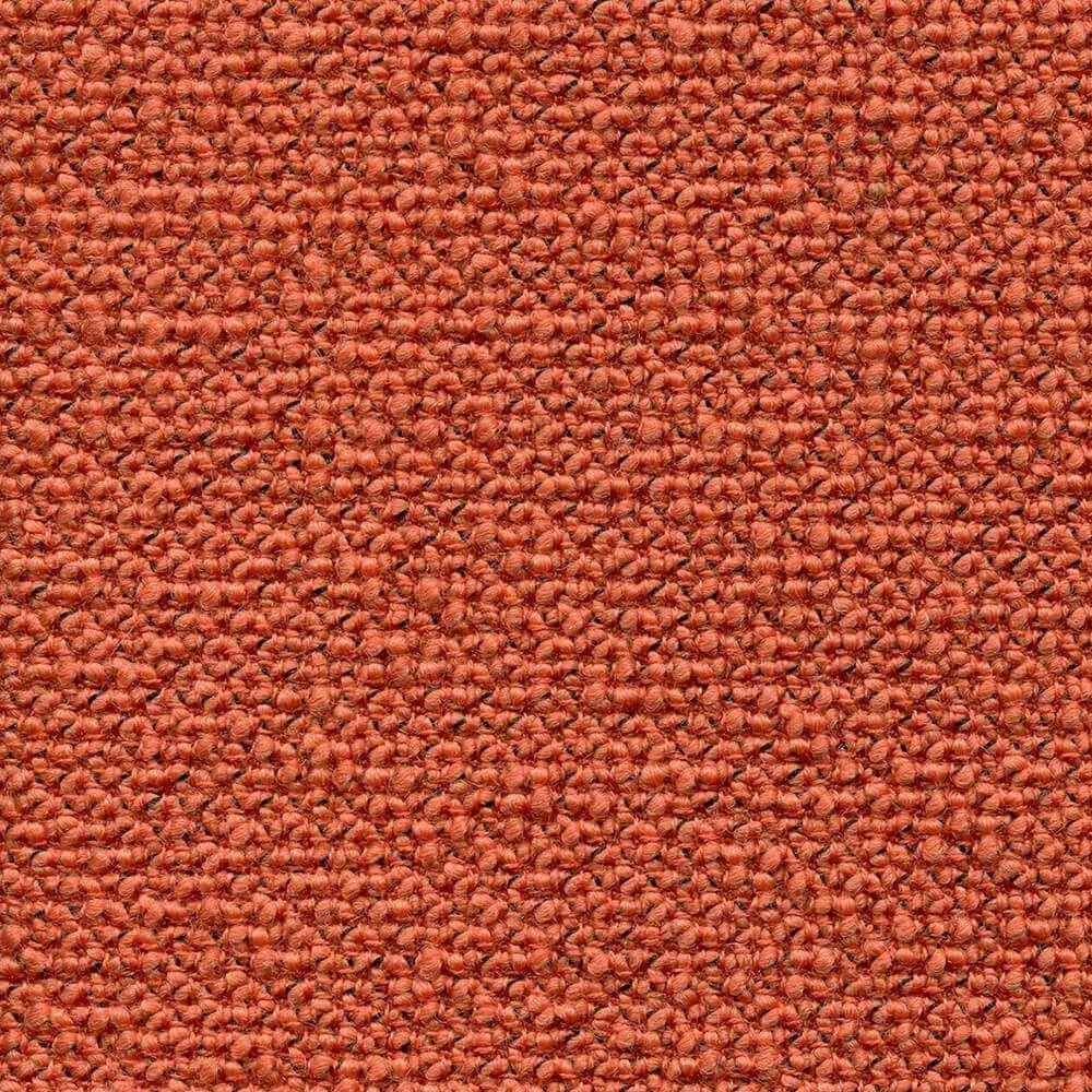 Close-up view of a textured orange fabric with a small pattern.