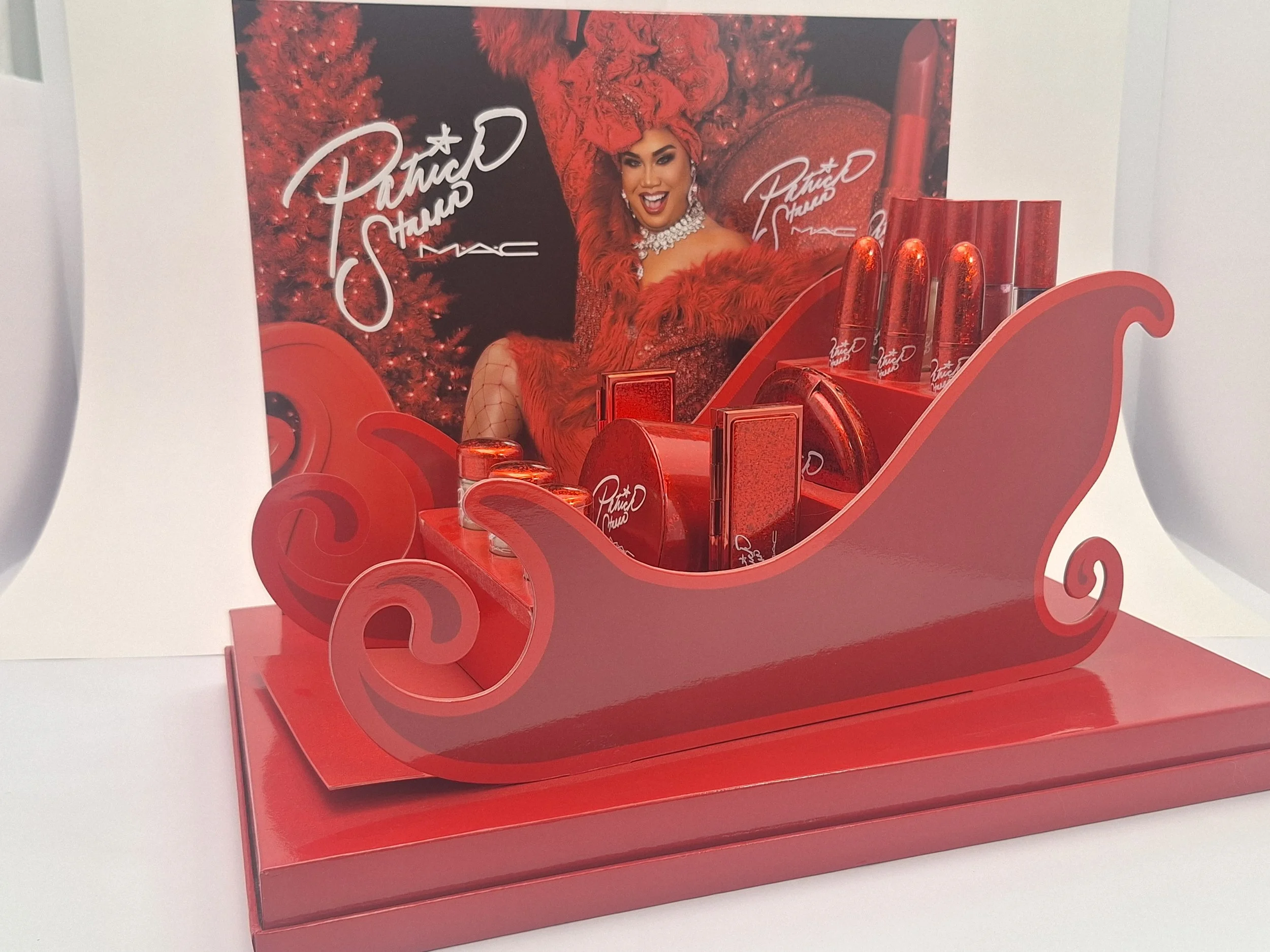 Close-up of M·A·C Sleigh Ride red and gold packaging and exclusive PR box display