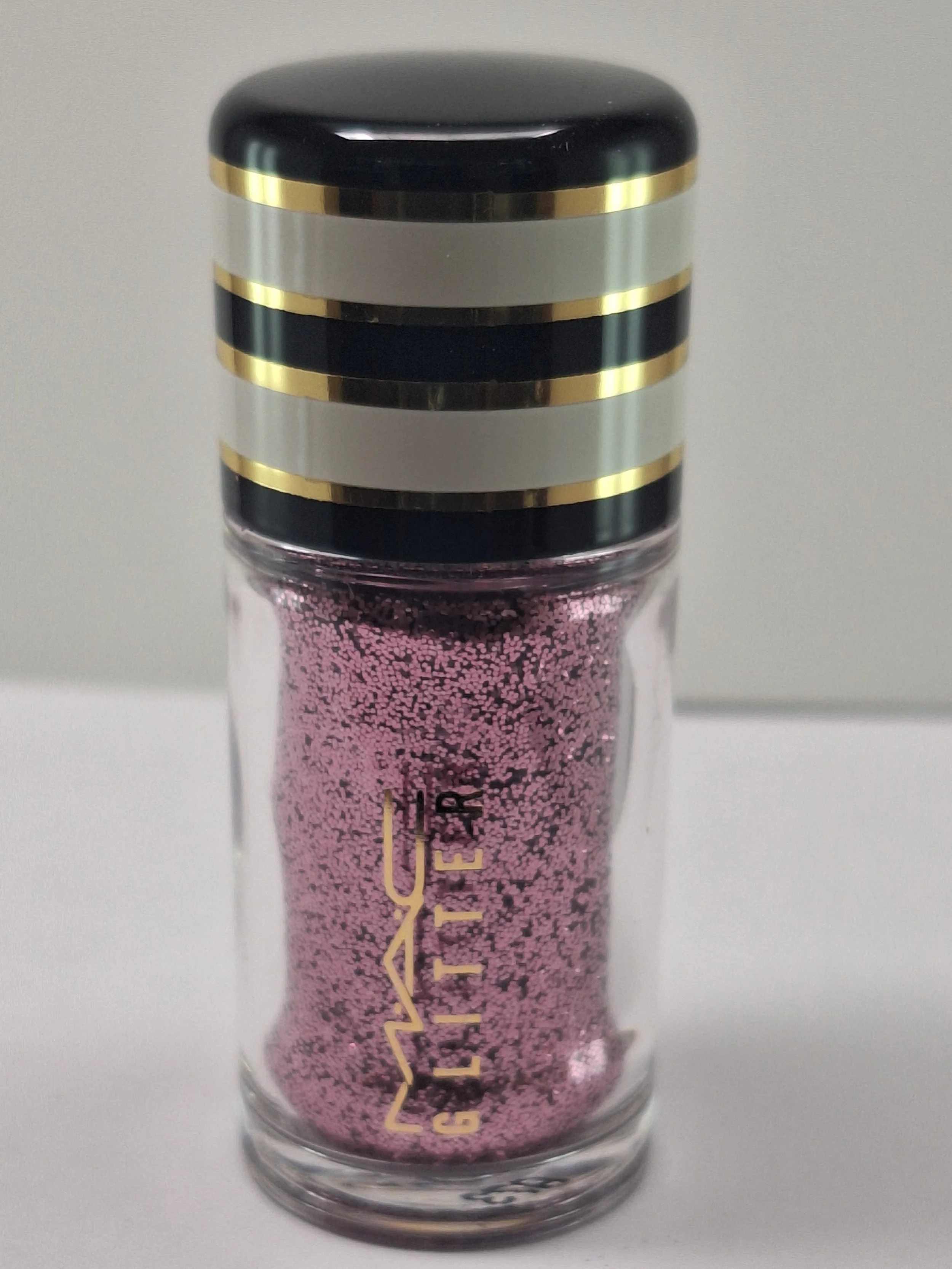 Close-up of M·A·C Nocturnal Holiday Collection mini jars with shimmering loose pigments