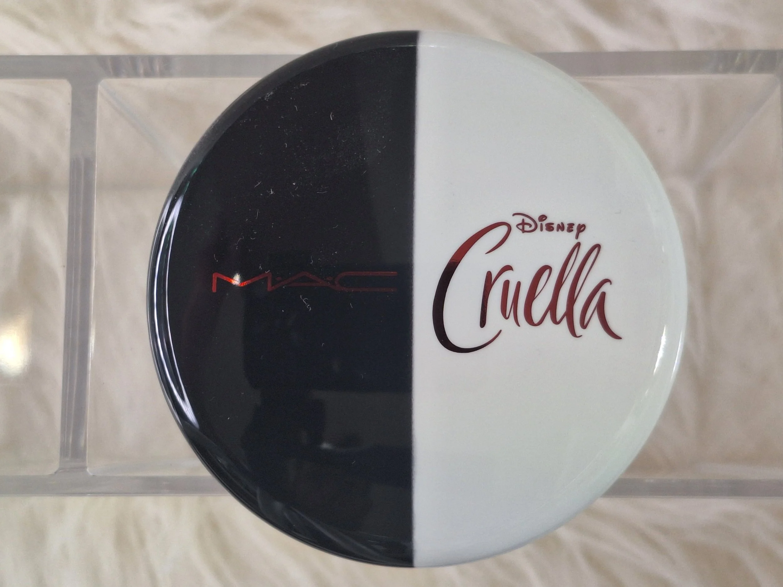 "Complete MAC Disney Cruella Collection including eyeshadow palette, lipsticks, liquid lip colours, blush duo, eyelashes, and exclusive packaging preserved by Sparkle Society."
