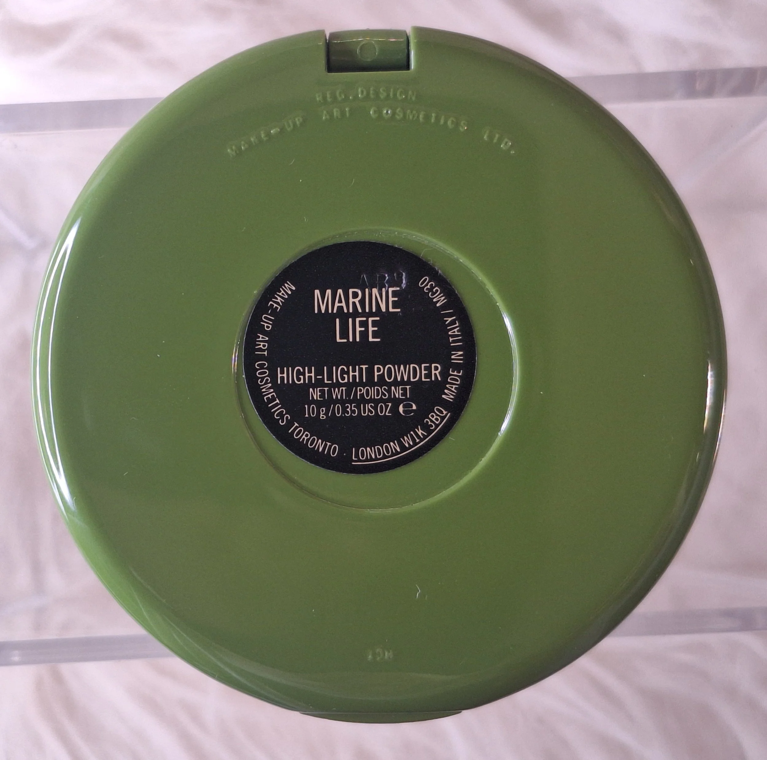 Back label of M·A·C Marine Life Highlight Powder compact showing product name and original Makeup Art Cosmetics details