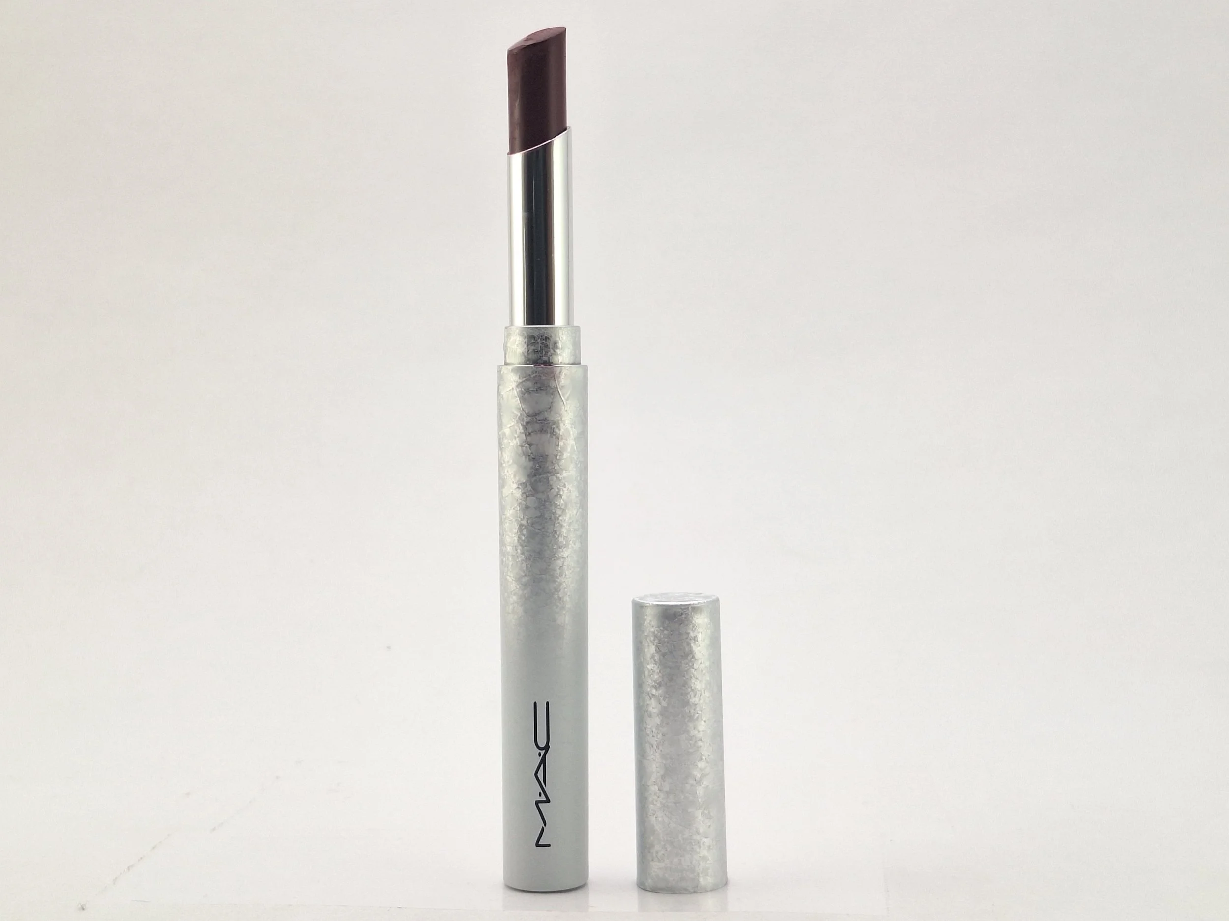 Close-up of a M·A·C Bizarre Blizzard Bash lipstick featuring festive holiday packaging from the 2023 limited-edition collection.