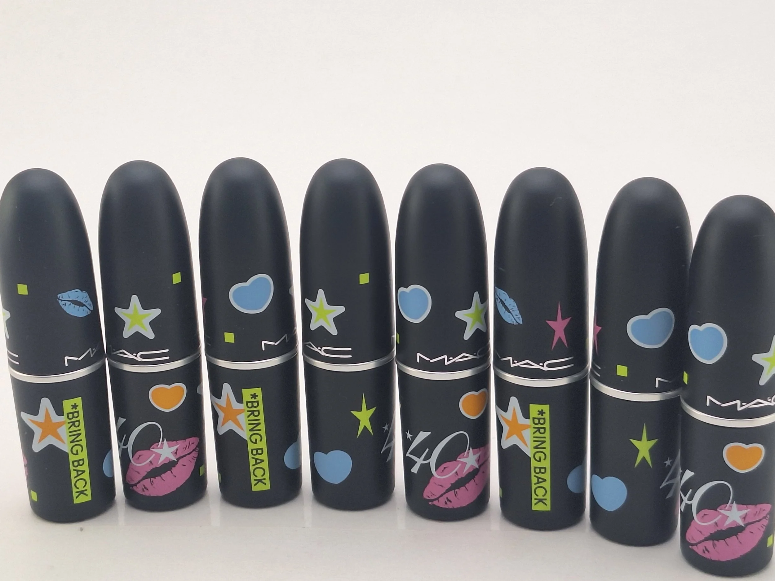 Set of MAC cosmetics lipstick tubes with colorful, playful designs and