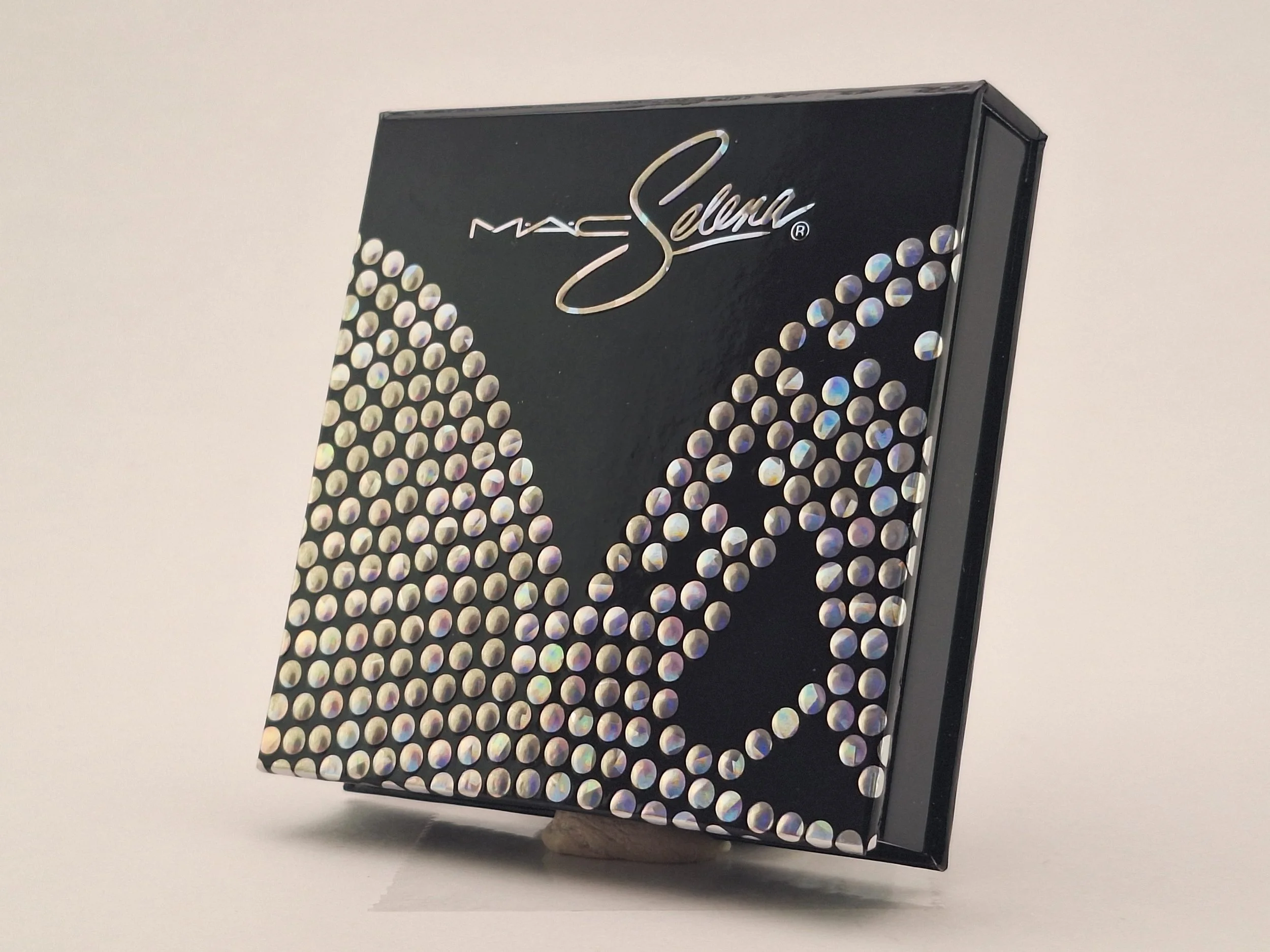 Close-up of M·A·C Selena La Reina Collection lipsticks, highlighters, eyeshadows, and collector packaging