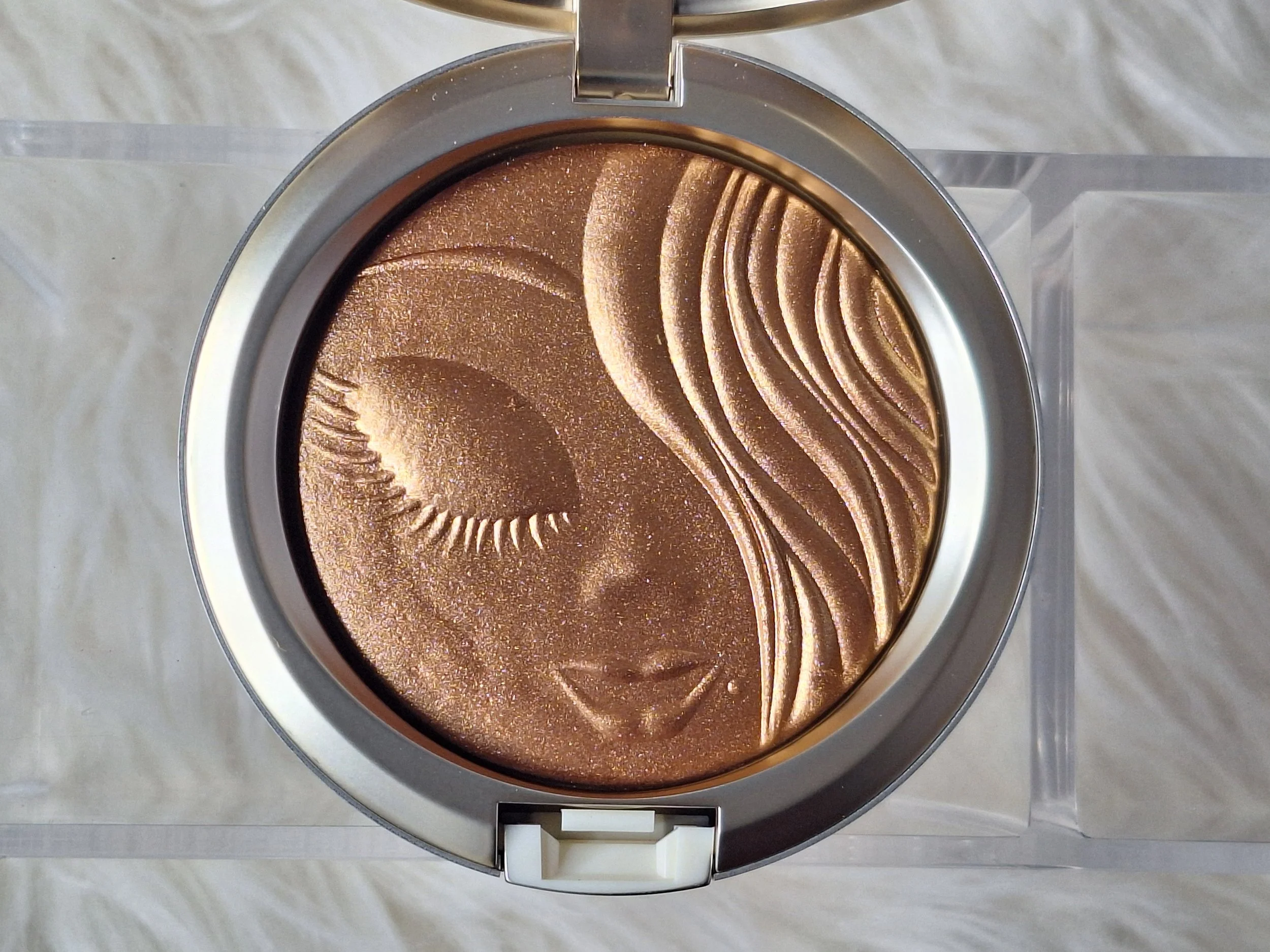Close-up of M·A·C Mariah Carey Collection diamond-dusted packaging and embossed powders