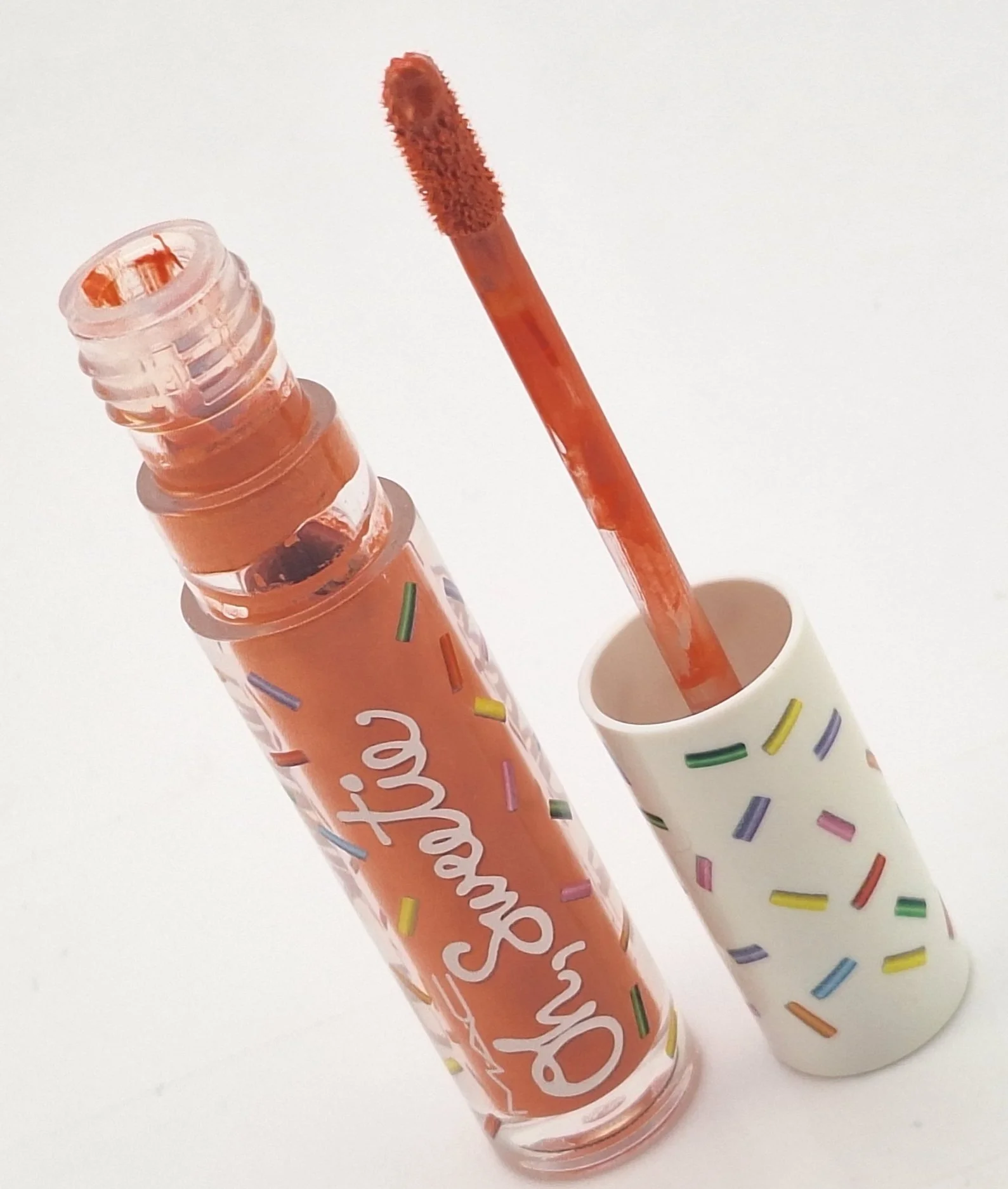 Close-up of M·A·C Oh, Sweetie Lipgloss packaging with vibrant, candy-colored caps