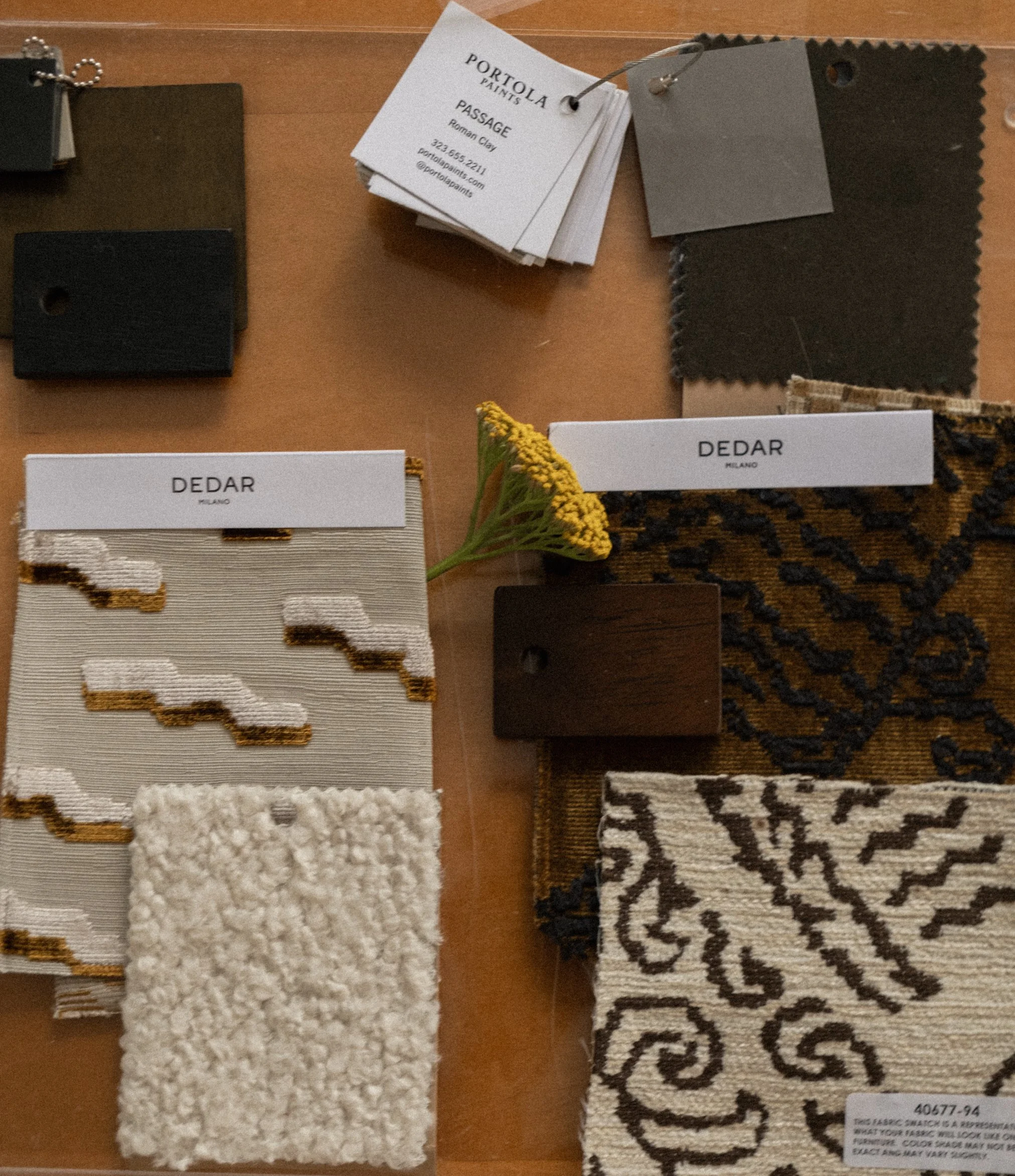 Interior design material selection board featuring fabric swatches, wood samples, and neutral color palettes