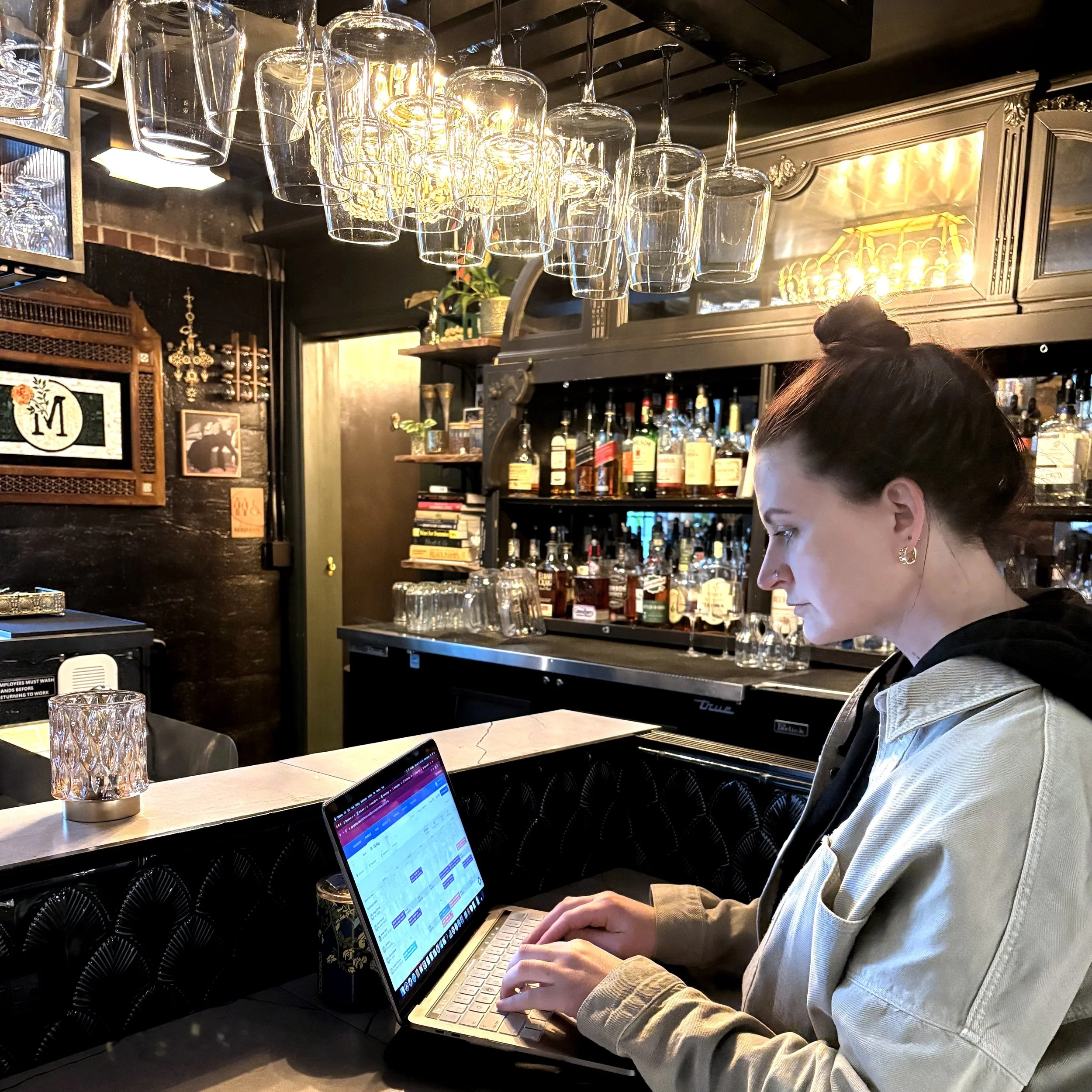 Fallan Keyser, founder of ALIGN, working at the bar at Melancholy in Salt Lake City