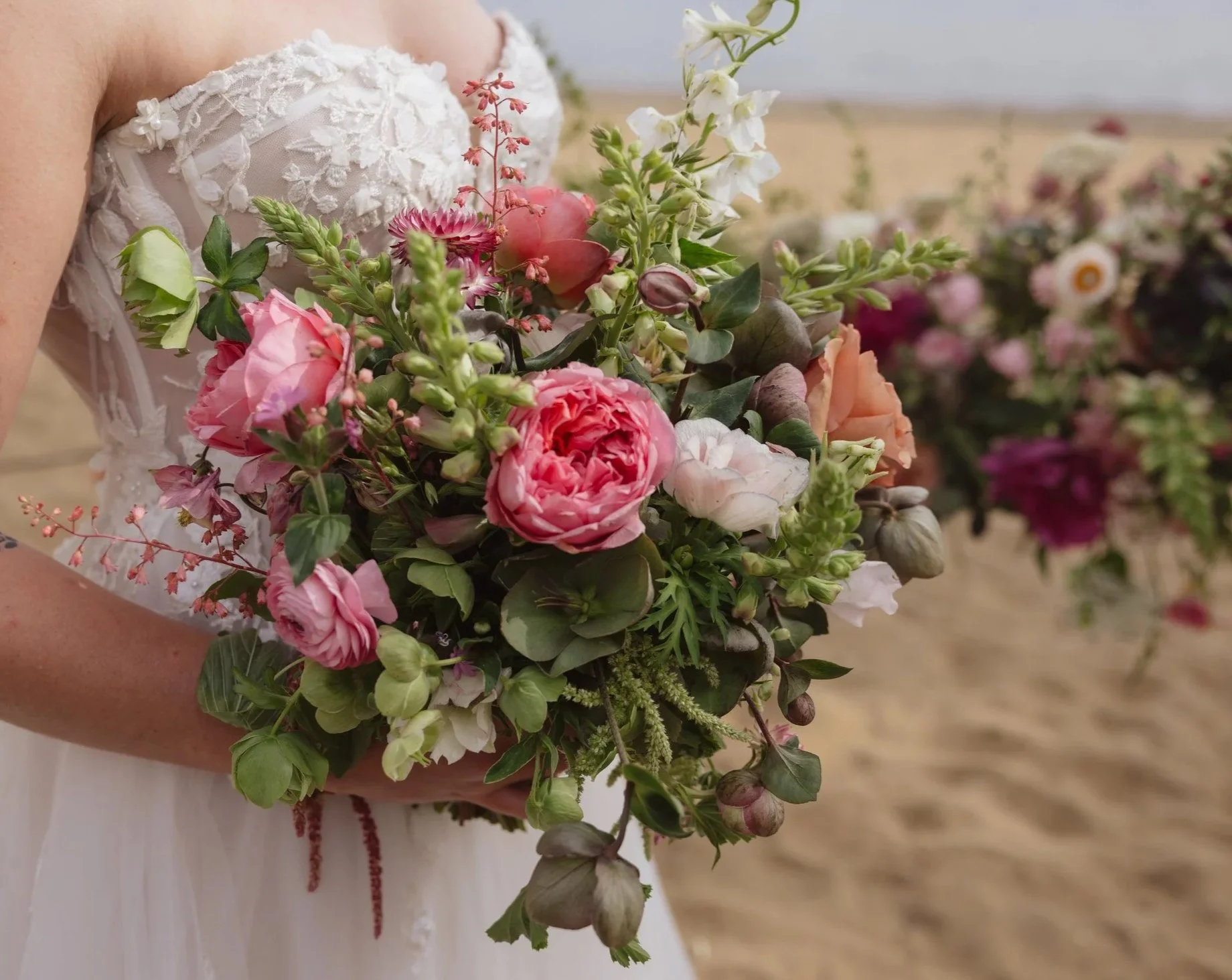 Bride holding bouquet by Golden Flowers