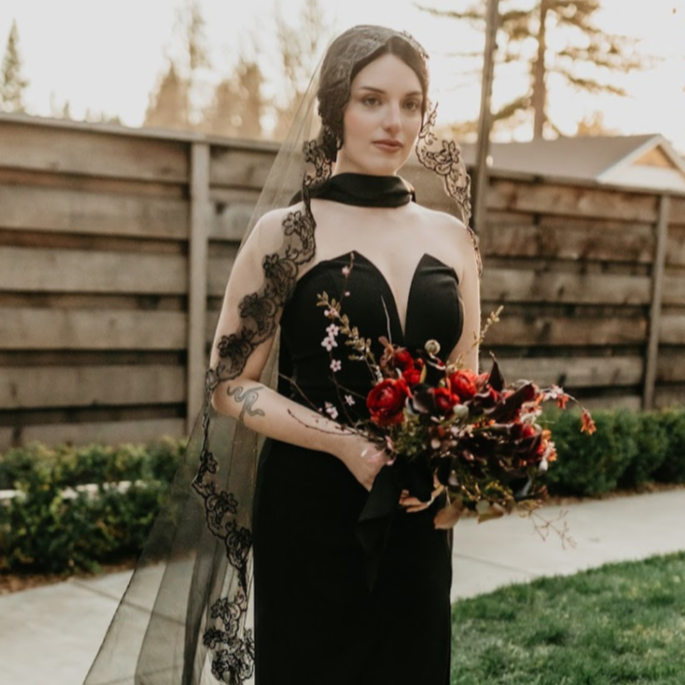 Bride holding bouquet by Golden Flowers