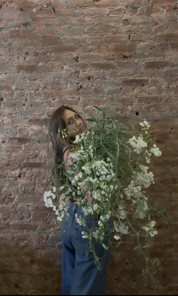 Lake Tahoe Wedding Florist holding cascading flowers in the design studio