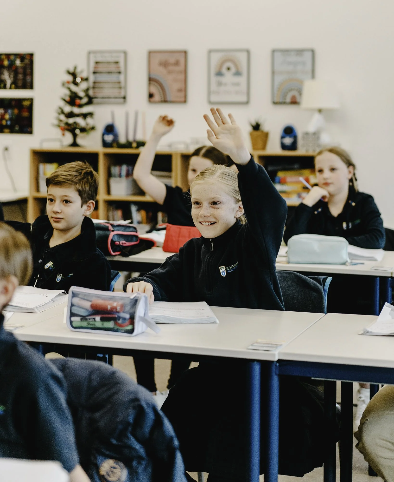 SMA Students sitting at desks in a classroom. 