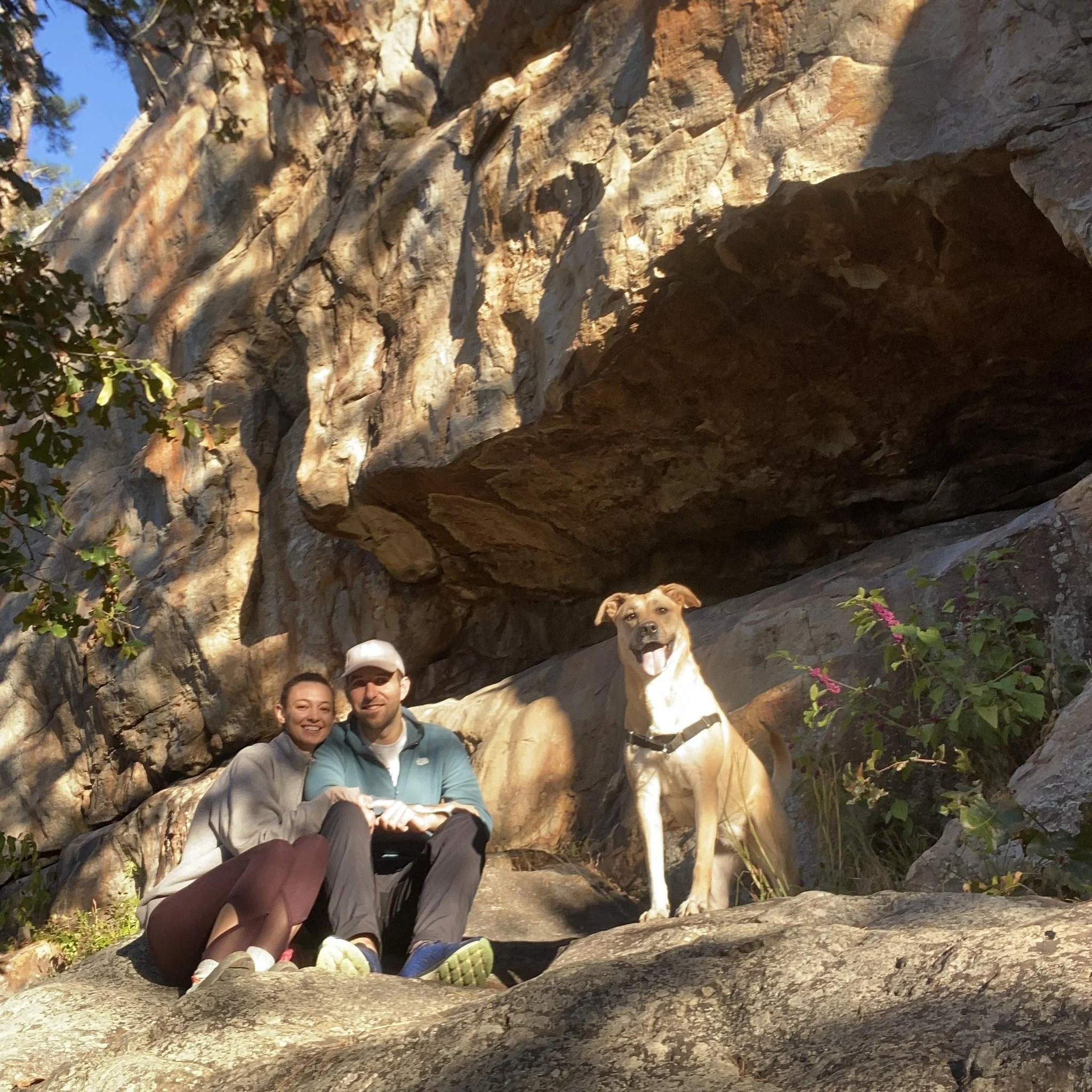 2 people and dog on bluff in ozarks 