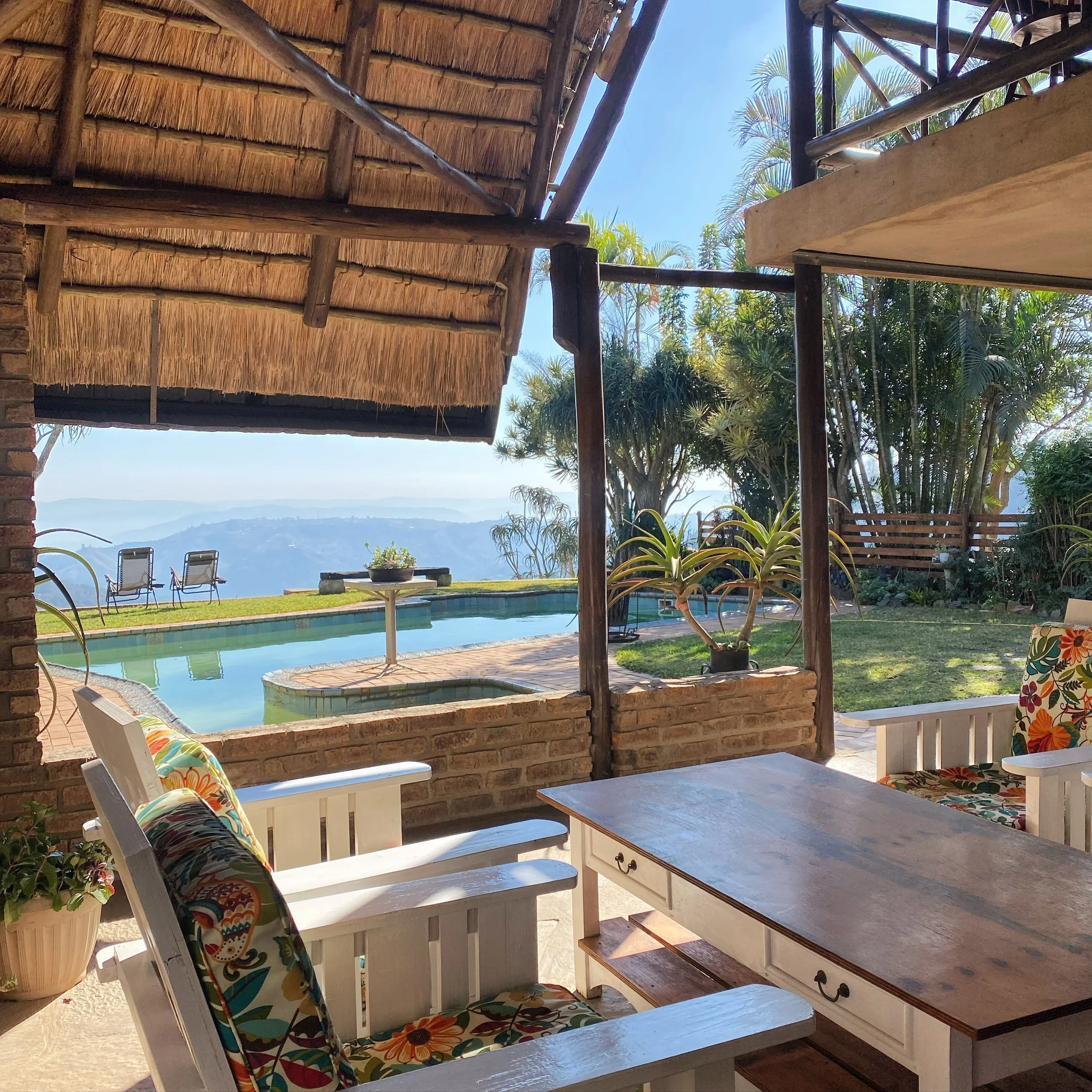 The Villa:
Covered patio with comfortable loungers creating a cozy atmosphere with a view 🫶